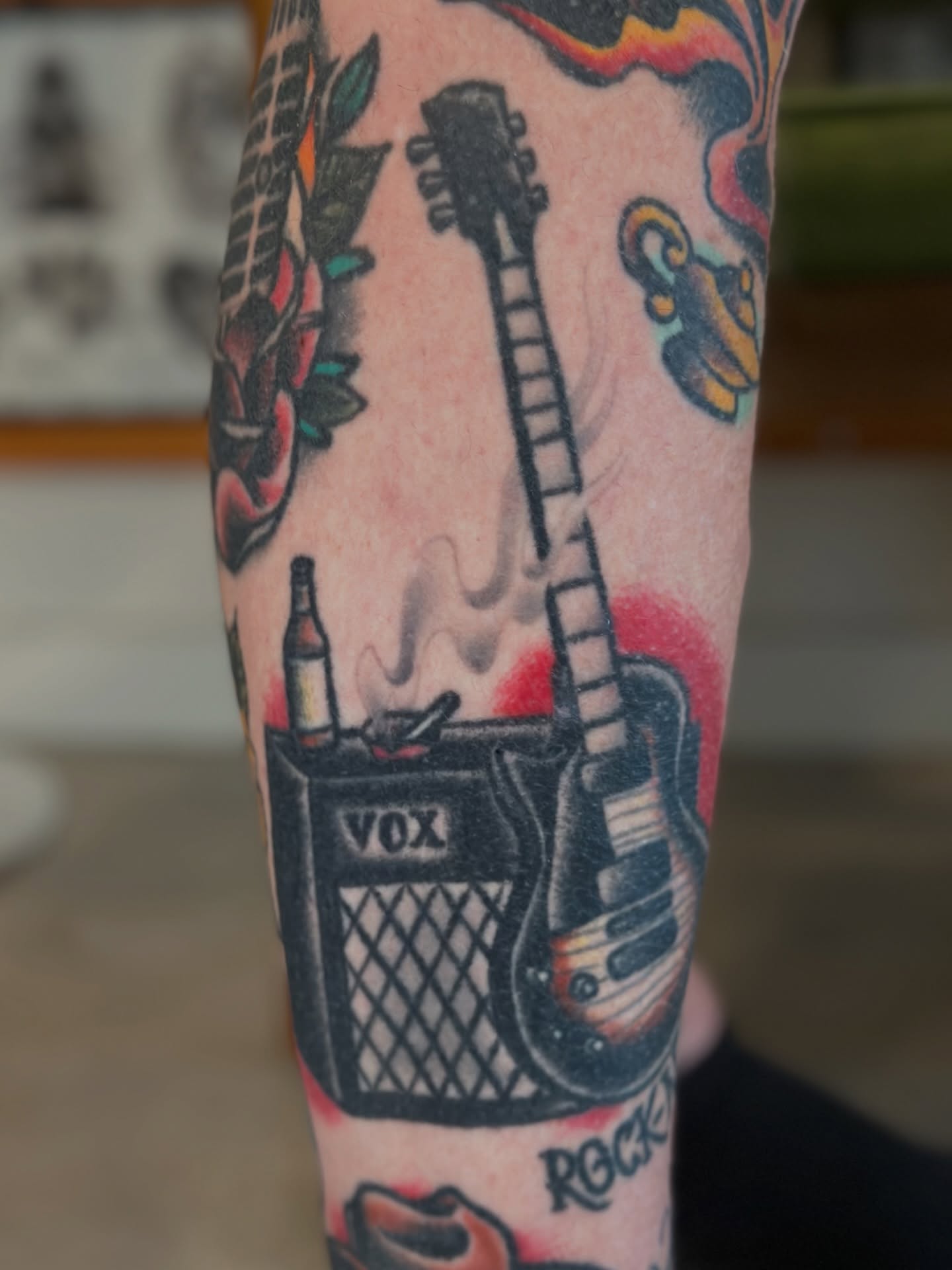 Electric guitar and amplifier American traditional tattoo on the forearm by Michael Williams