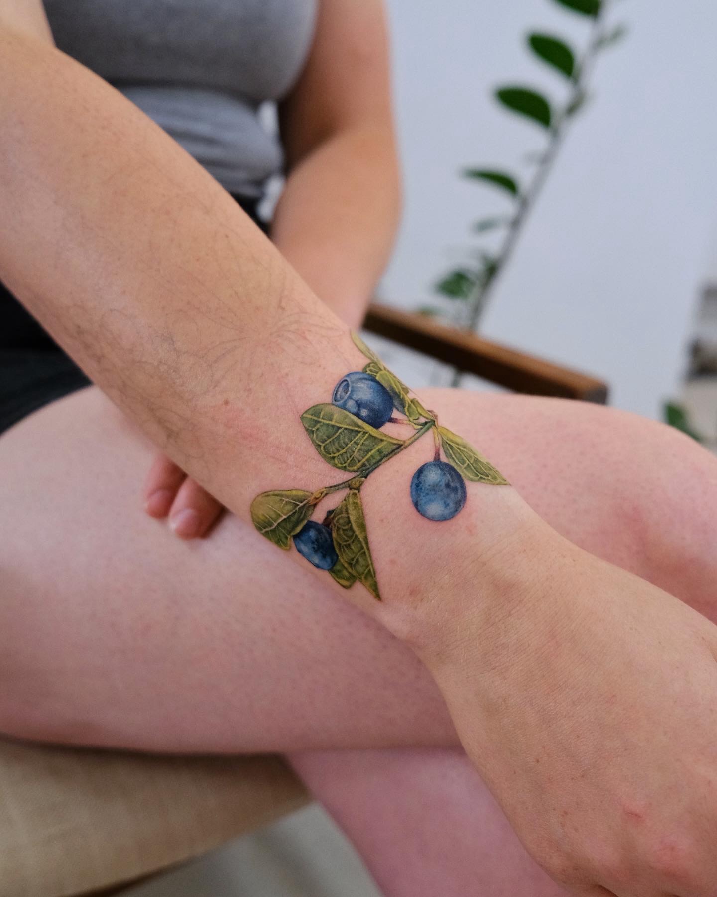 Blueberries realism tattoo on the forearm by Jiemin Lin