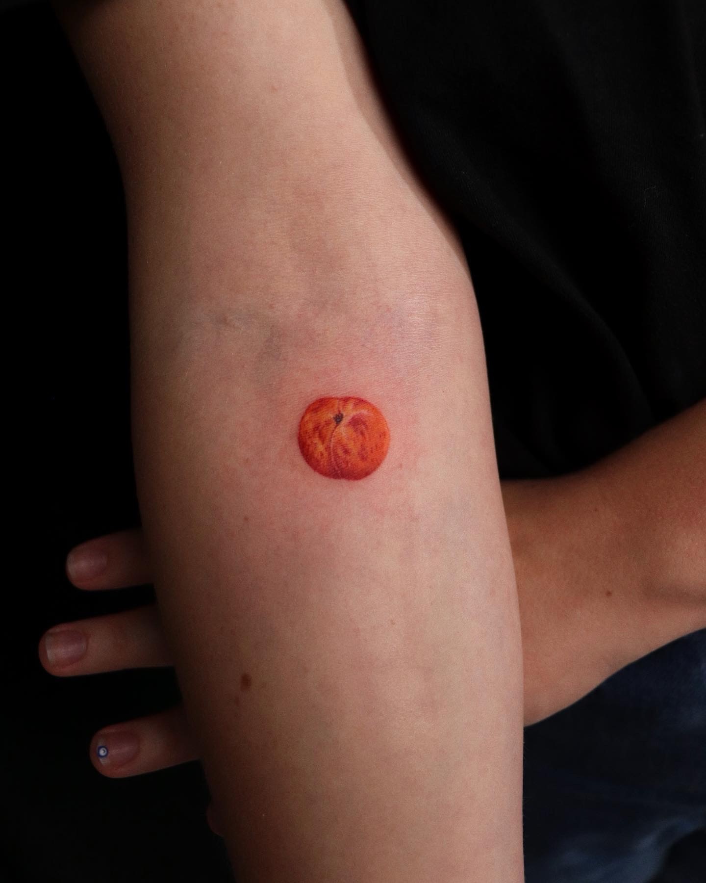 Peach realism tattoo on the forearm by Jiemin Lin