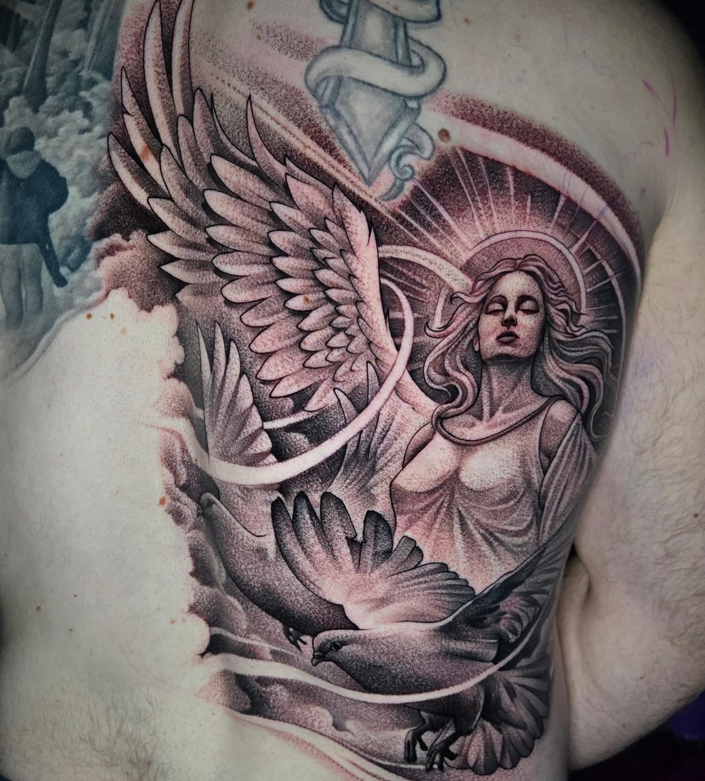 Angel with dove dotwork tattoo on the thigh by Jeff Stager