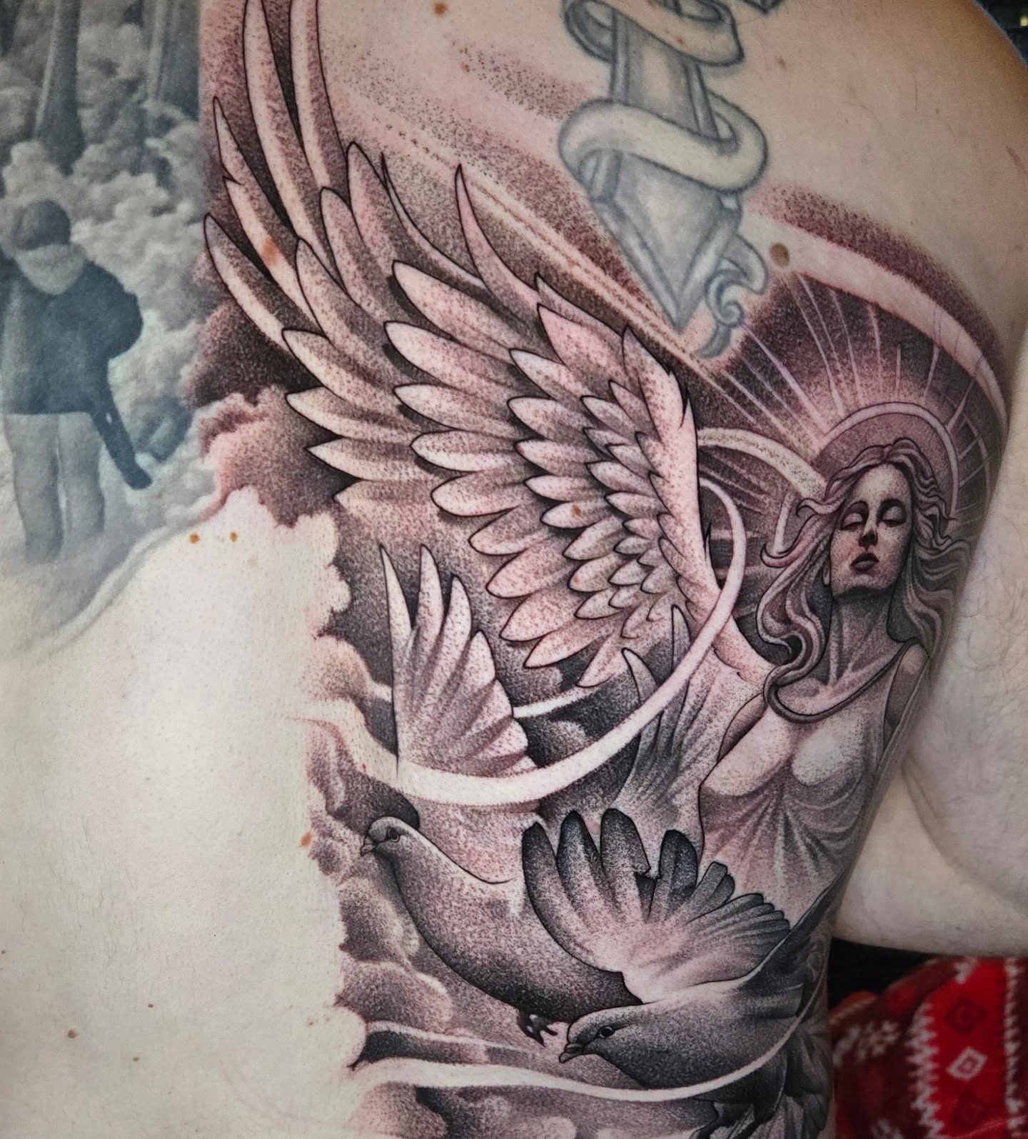 Angel with wings realism tattoo on the shoulder by Jeff Stager