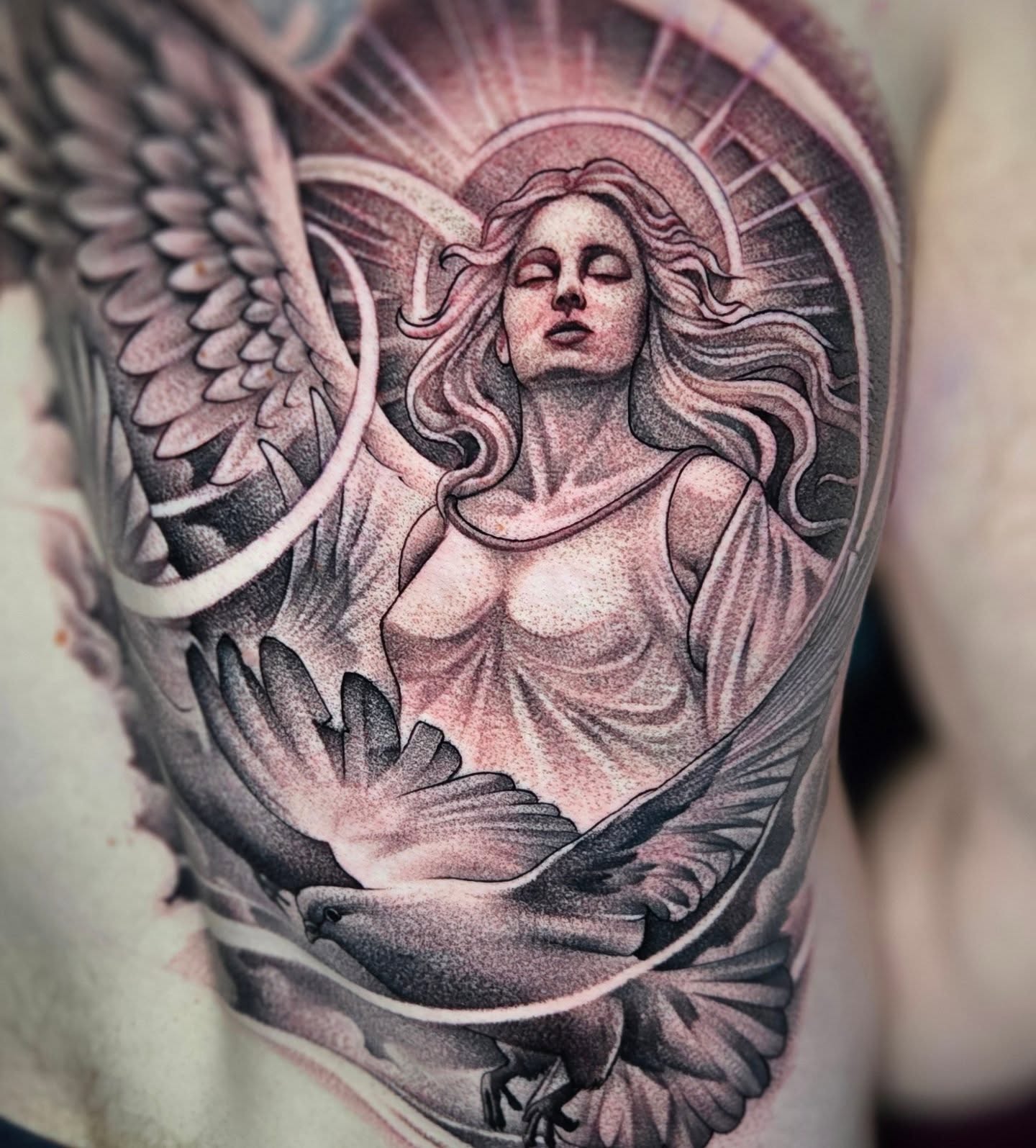 Angel with dove dotwork tattoo on the shoulder by Jeff Stager