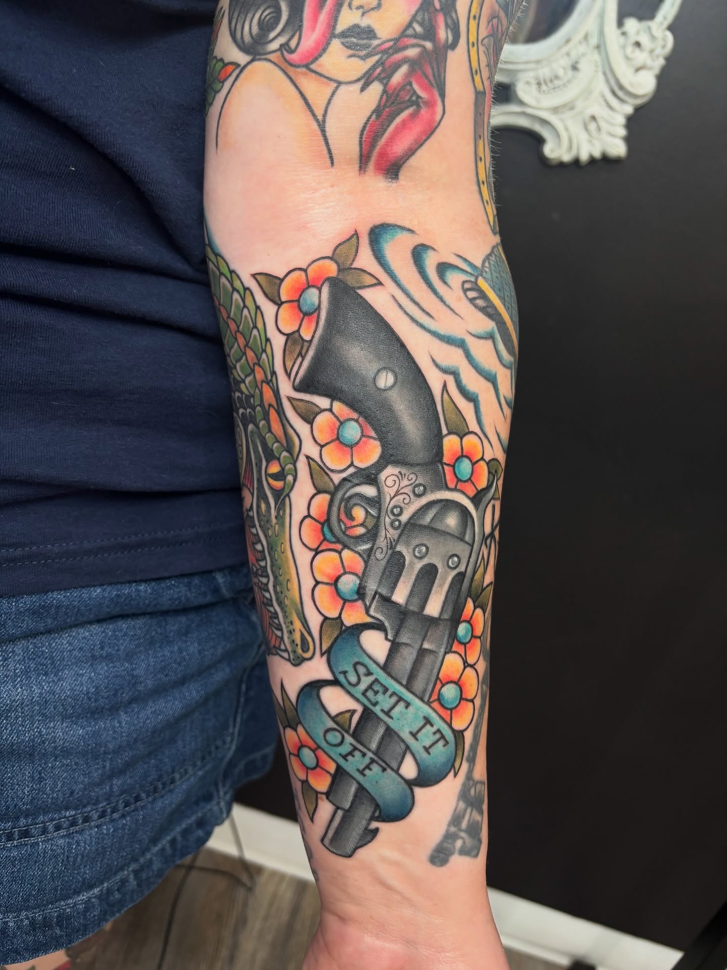 Revolver and woman American traditional tattoo on the forearm by Shiann Null