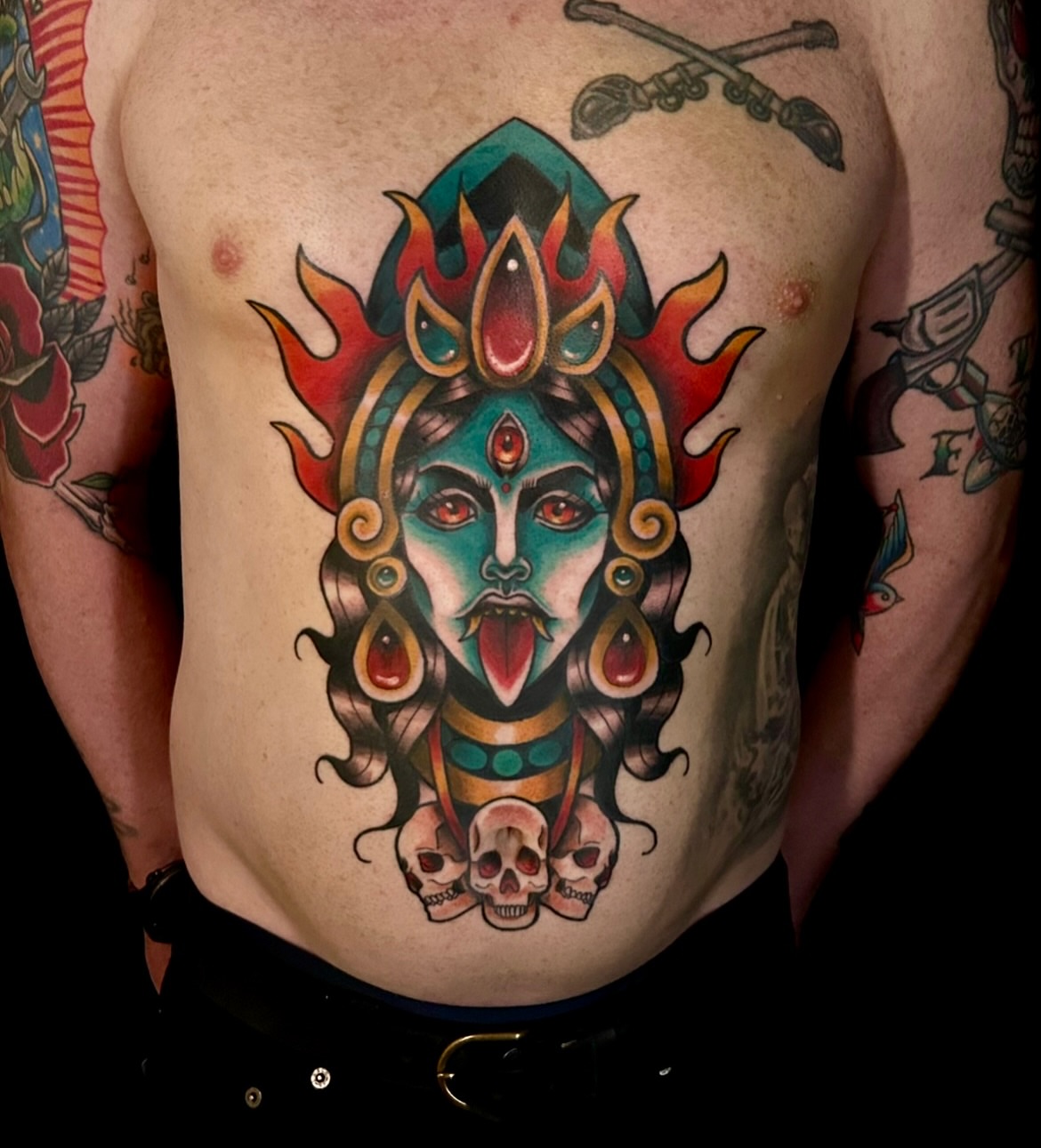 Deity with skulls American traditional tattoo on the chest by Kim Goff - Special K
