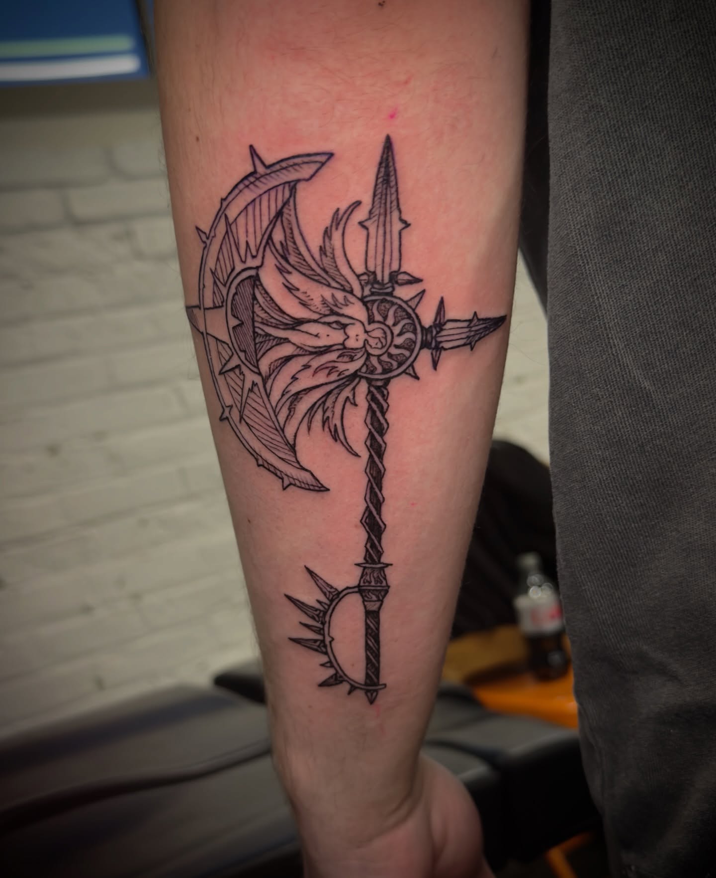 Ax and key black and grey tattoo on the forearm by Jeff Brock