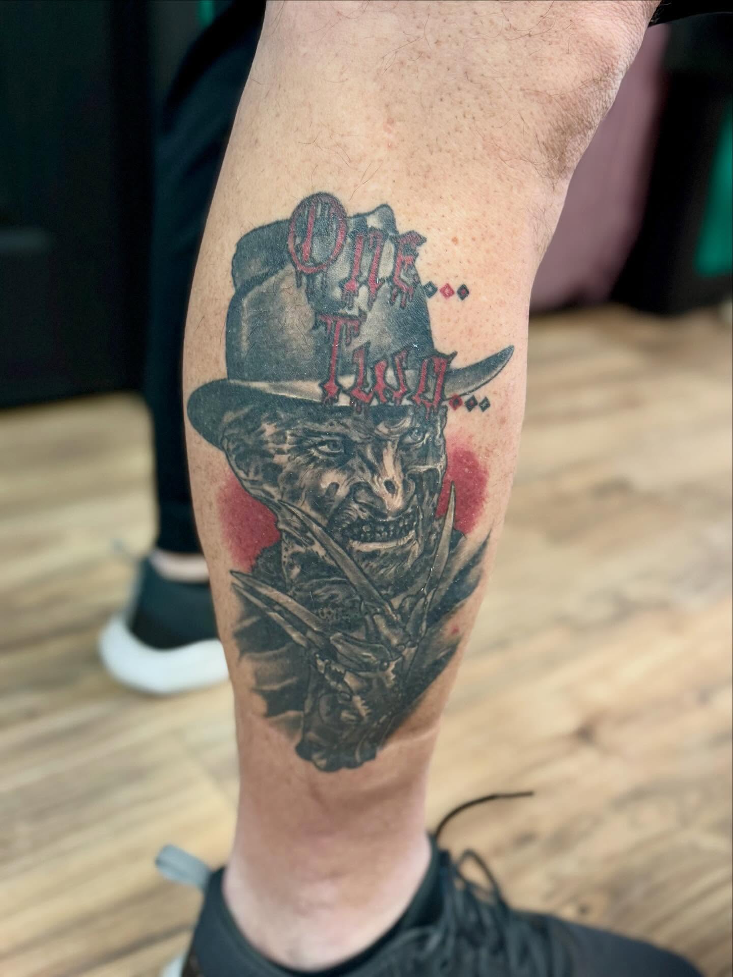 Skull wearing top hat realism tattoo on the forearm by Eileen Joyce