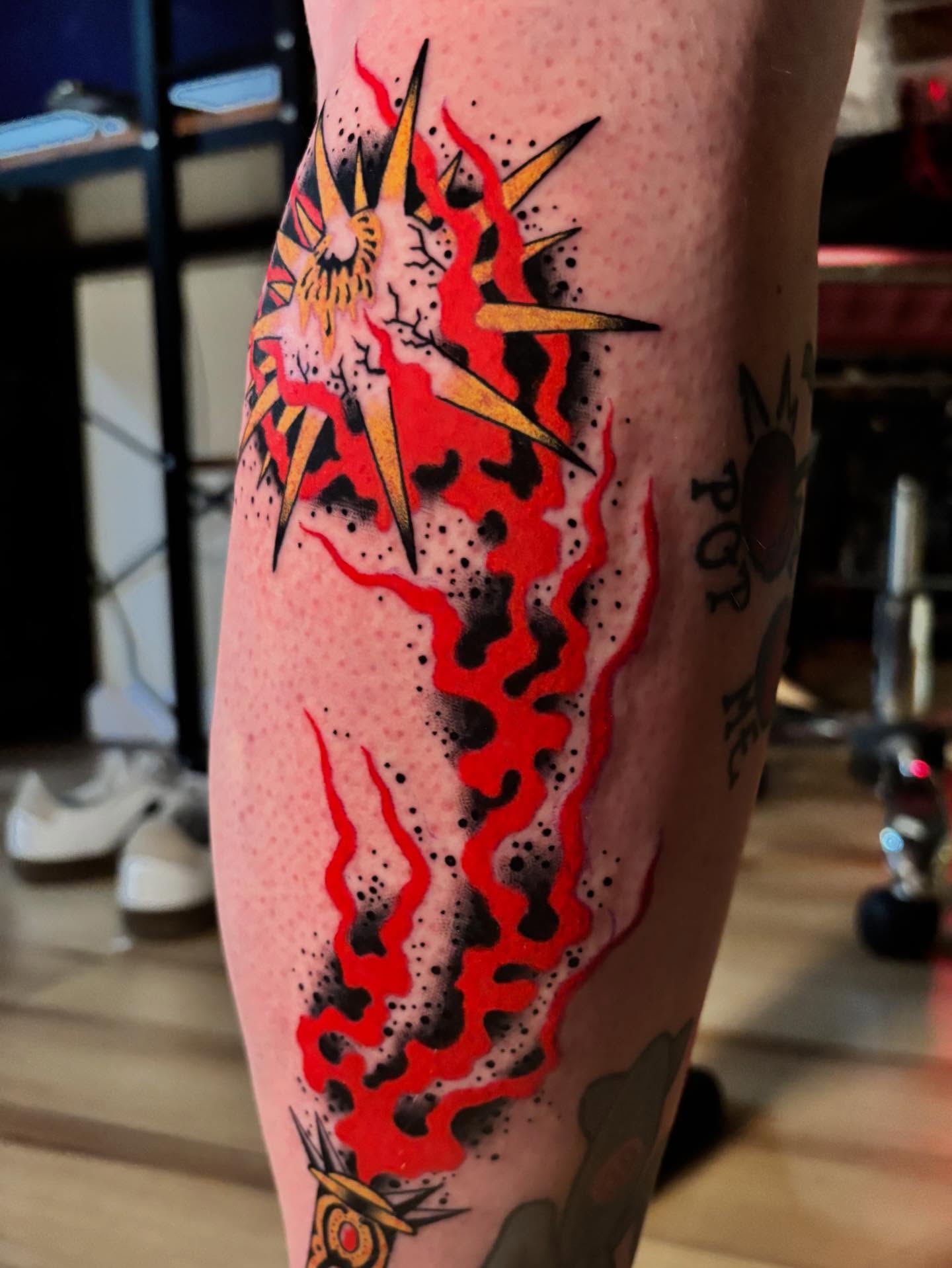Heart with flames American traditional tattoo on the calf by Tyler Whalen
