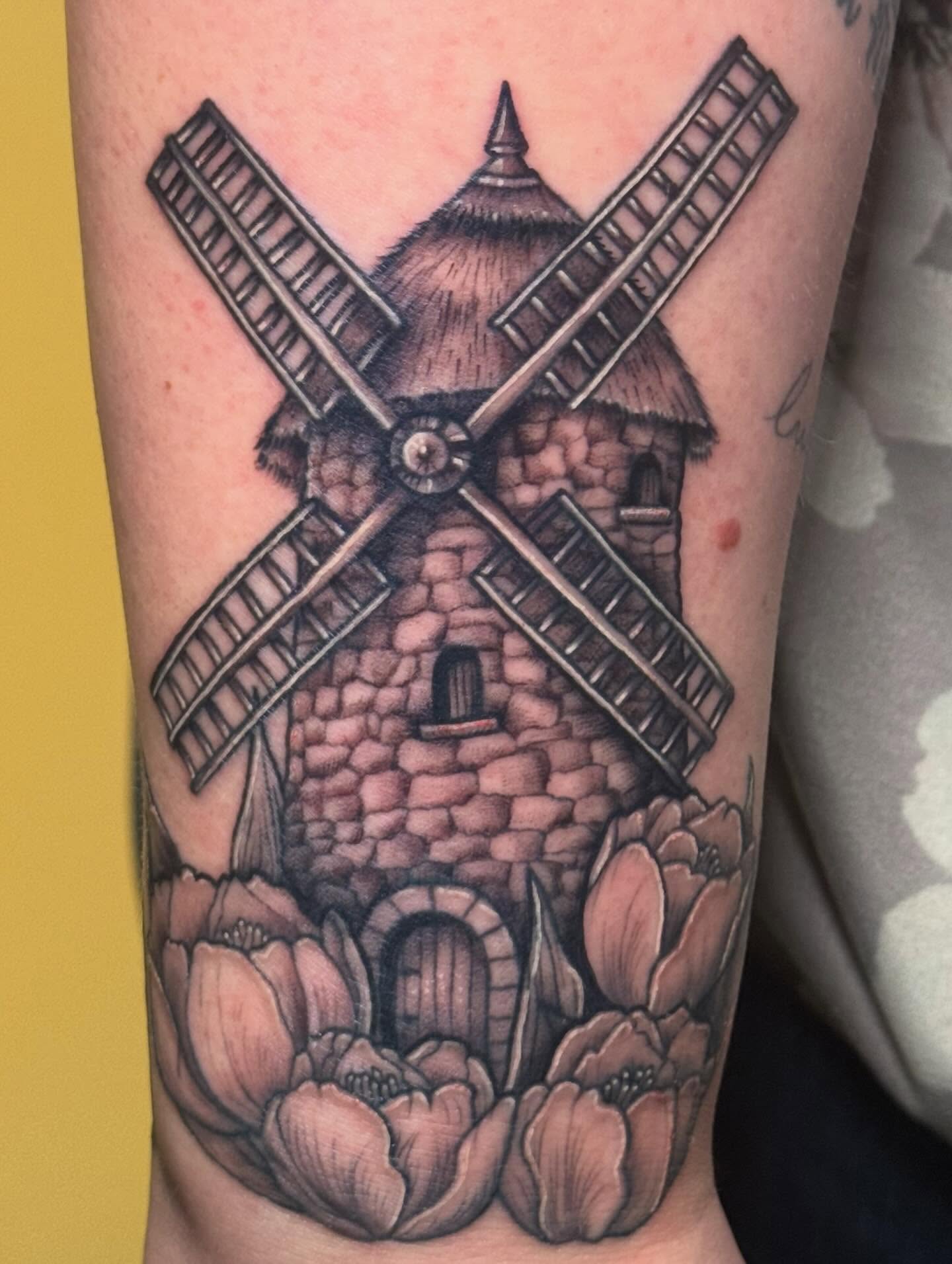 Windmill realism tattoo on the forearm by Madison Pegram
