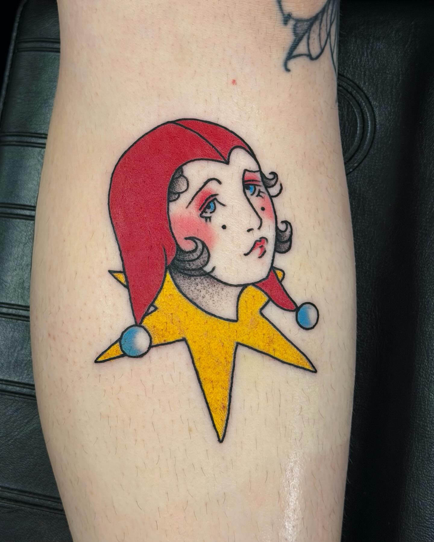 Jester American traditional tattoo on the forearm by Emily