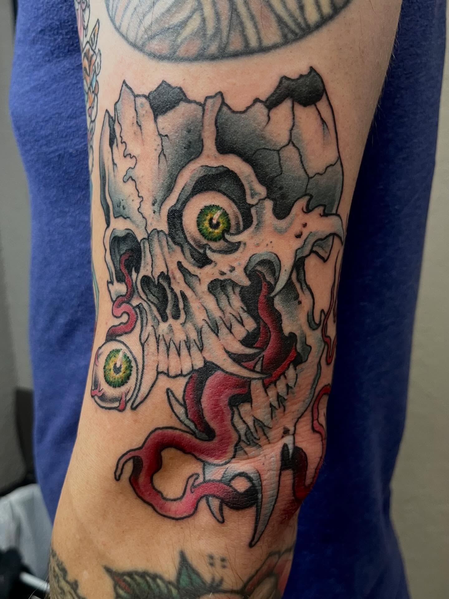 Skull with eyes and serpents dark realism tattoo on the forearm by Allie Tippets, Gilbert, Arizona