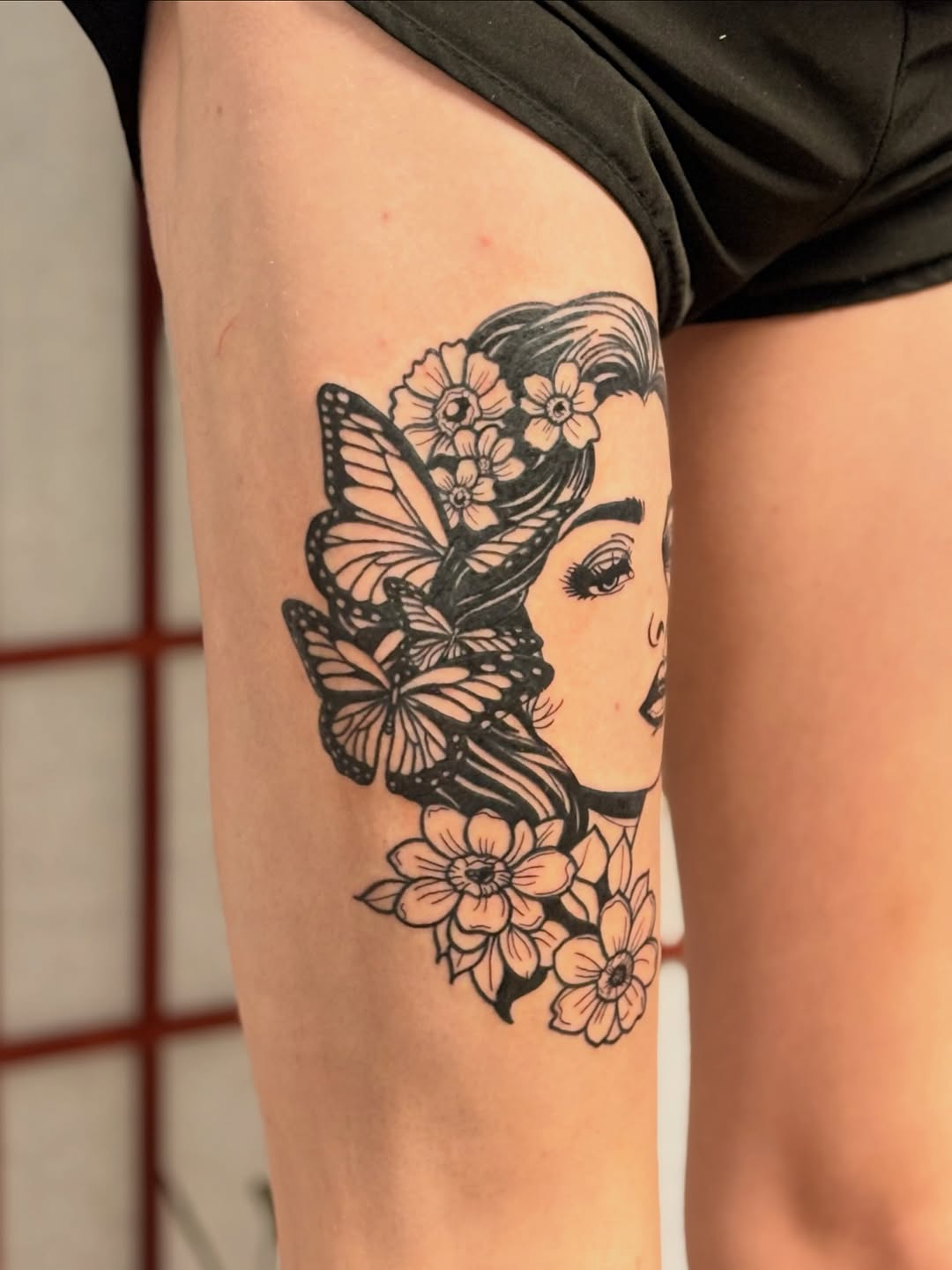 Woman with butterflies and flowers fine line tattoo on the thigh by CJ