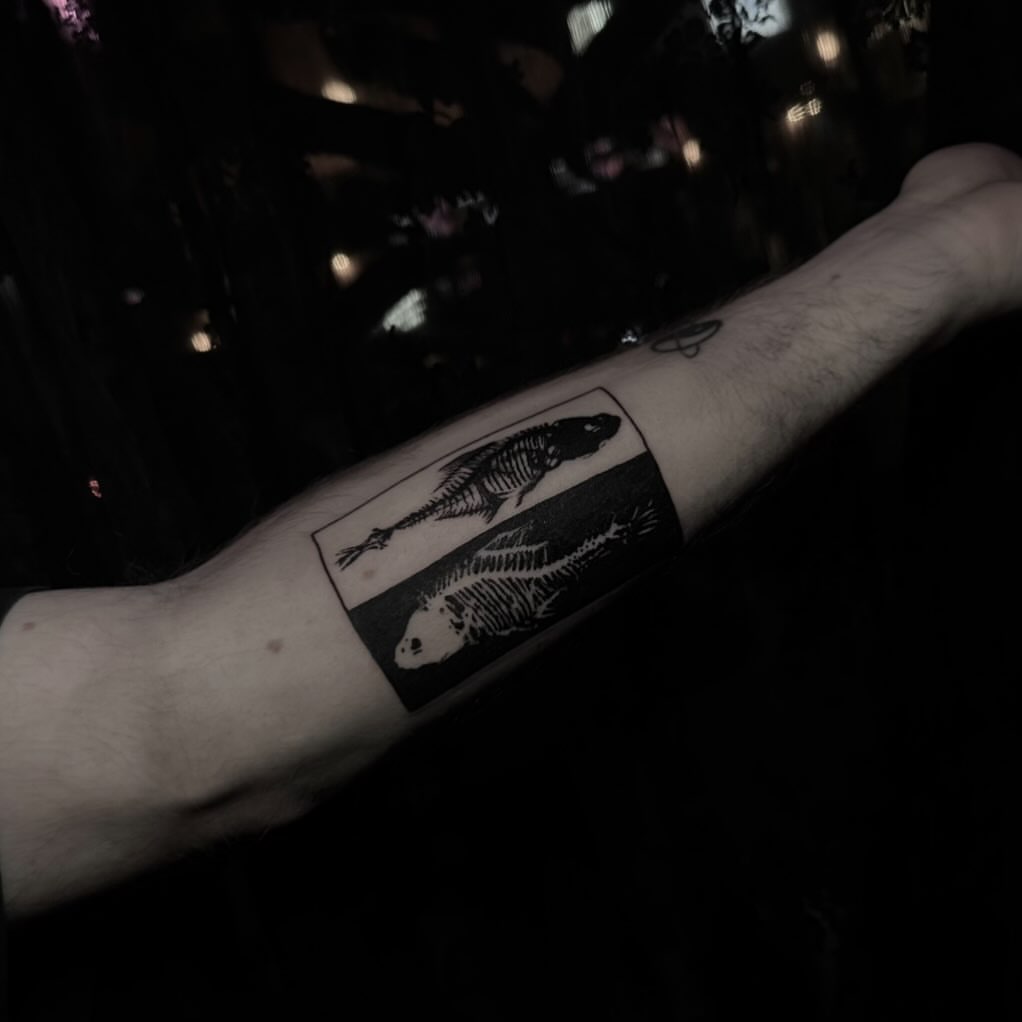 Fish skeleton black and grey tattoo on the forearm by Abigail Rae
