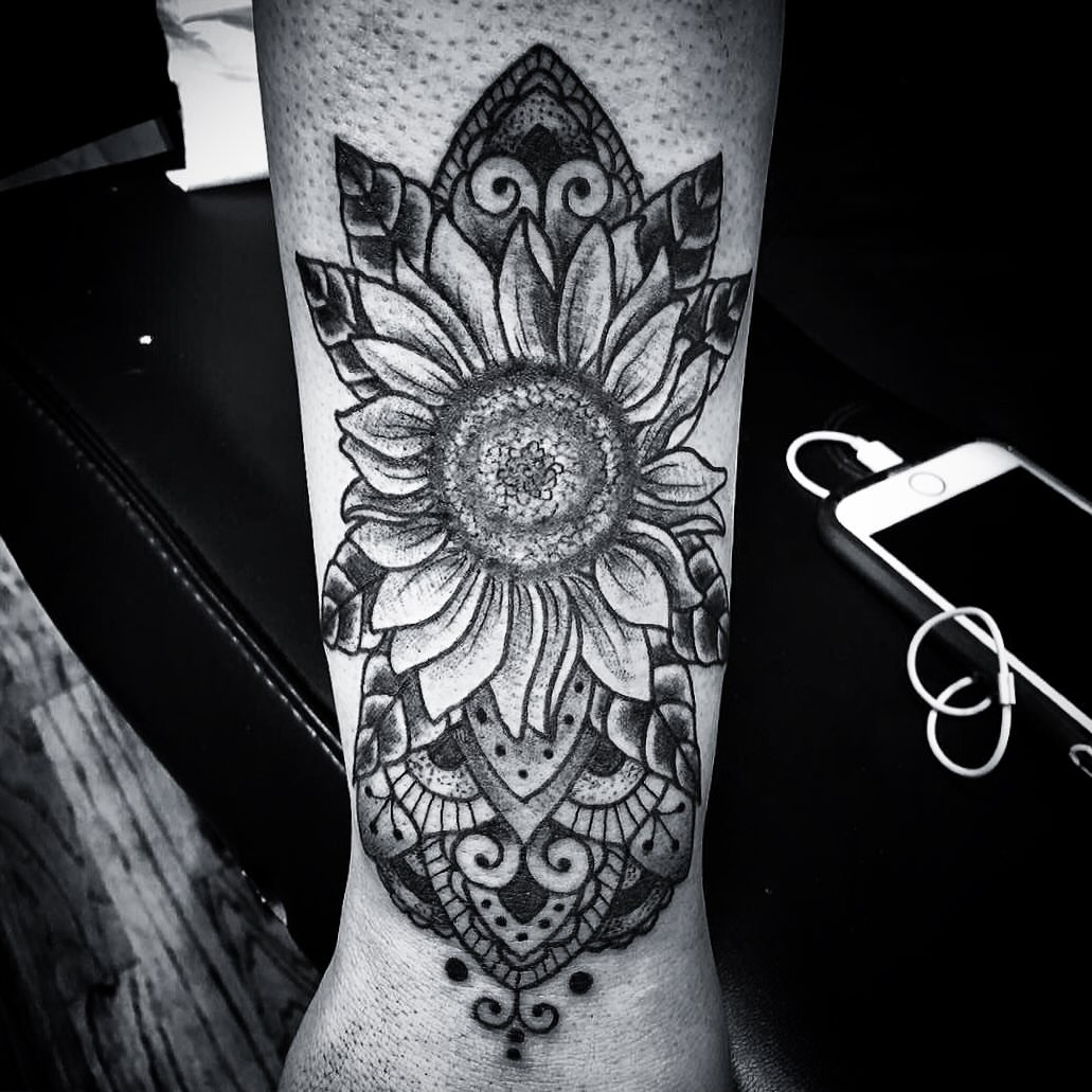 Sunflower dotwork tattoo on the calf by Suzanne B