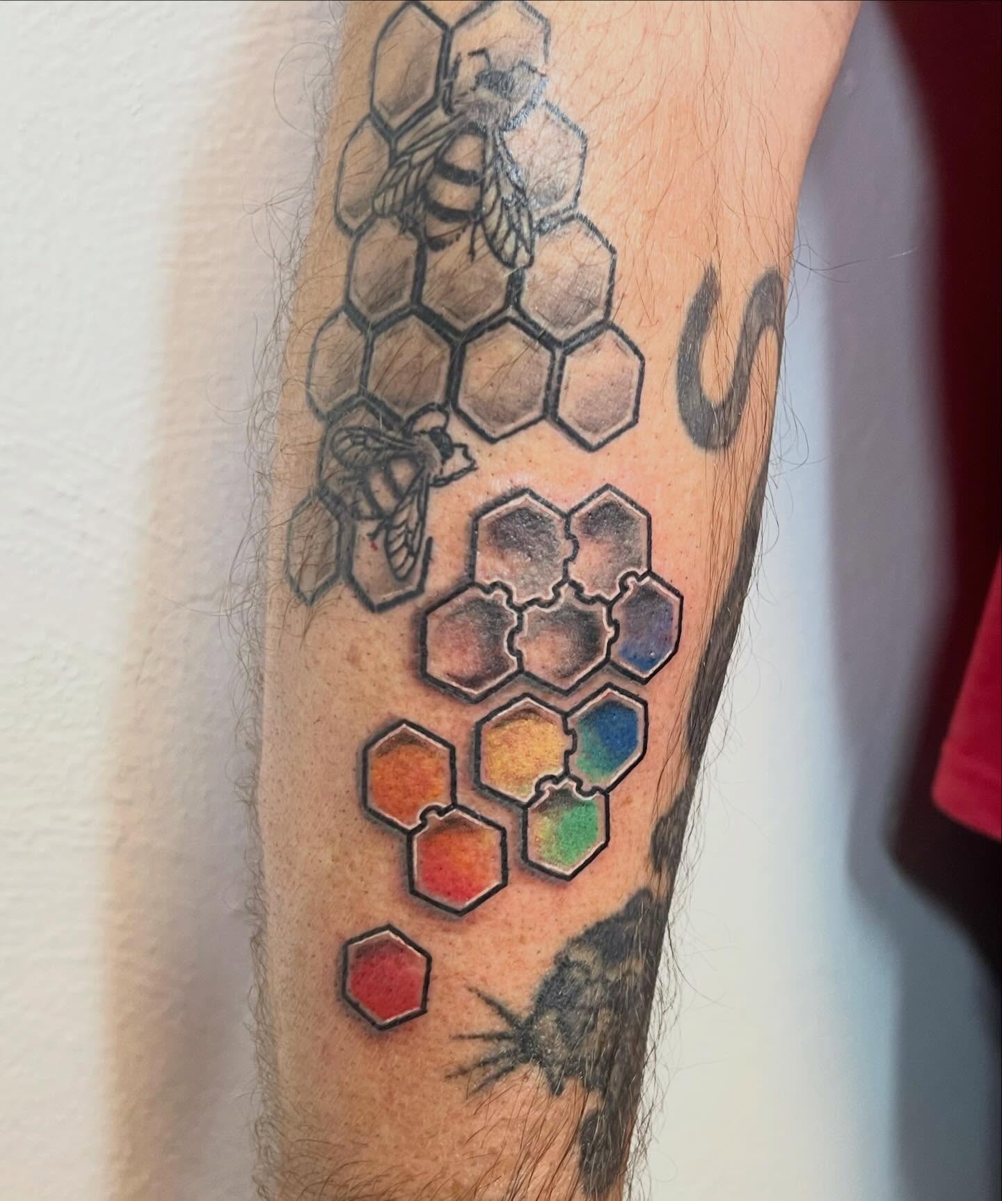 Honeycomb pattern with bees geometric tattoo on the forearm by Amber Rose