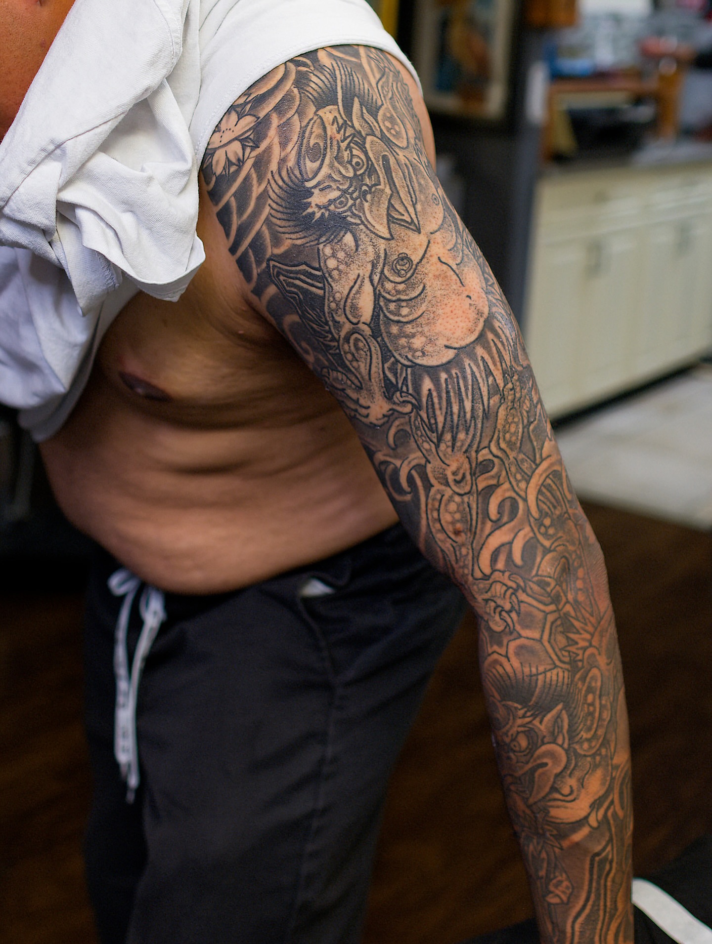Lion and dragon japanese irezumi tattoo on the upper arm by Chris Cockrill