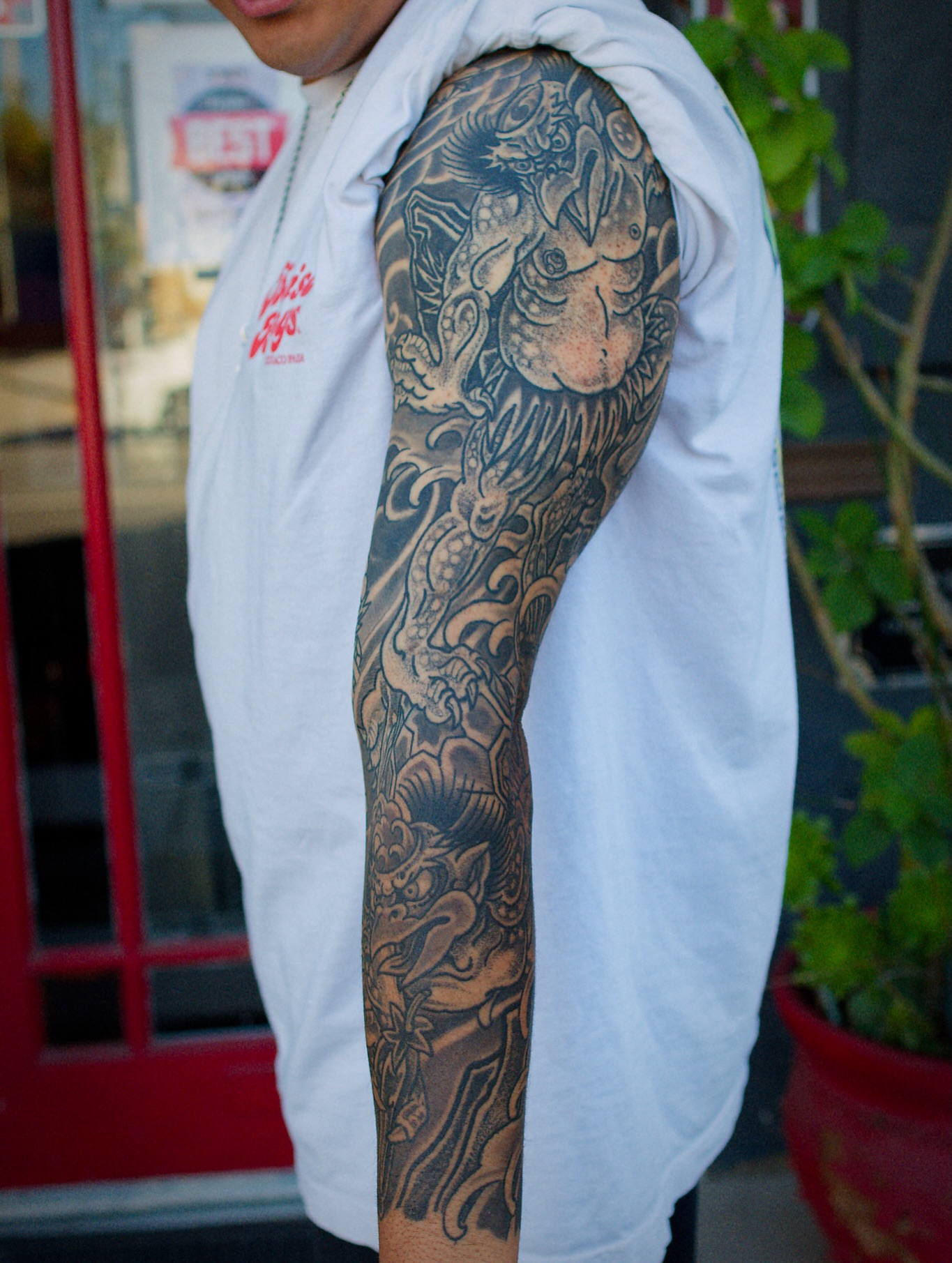 Dragon and mythical creature japanese irezumi tattoo on the forearm by Chris Cockrill