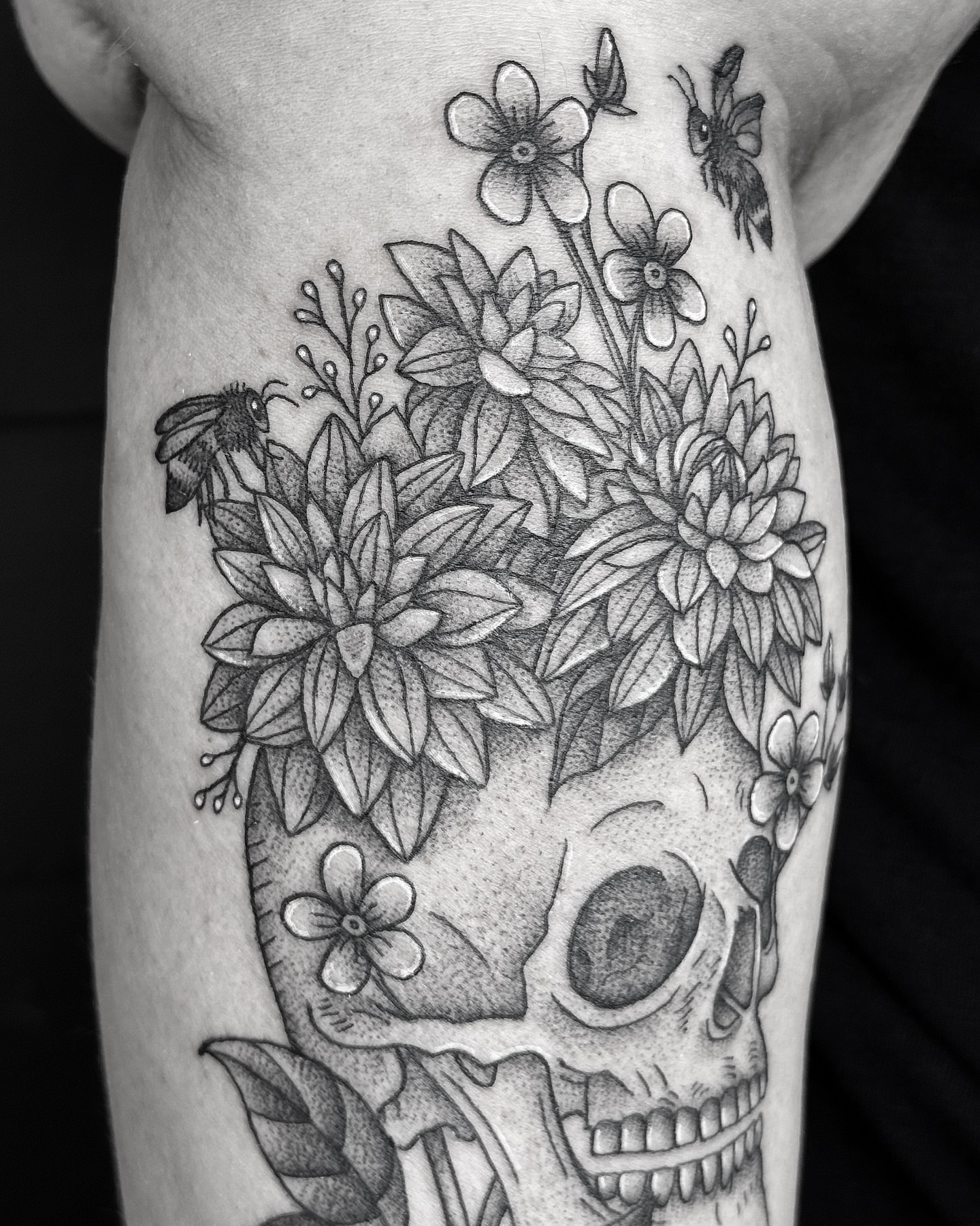 Skull with flowers dotwork tattoo on the forearm by Breezy Tucker