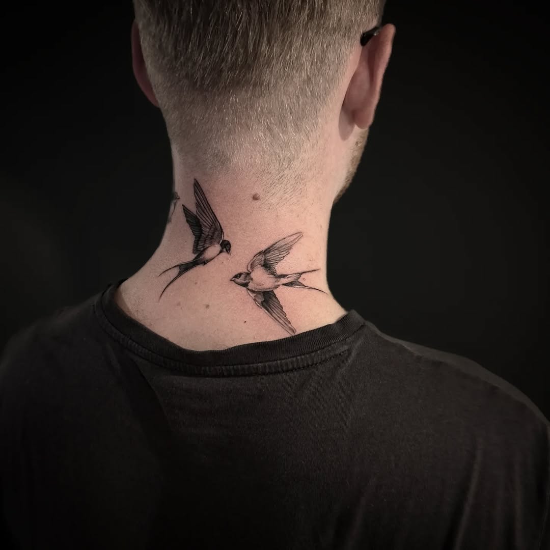 Two swallow birds fine line tattoo on the neck by Lindsay