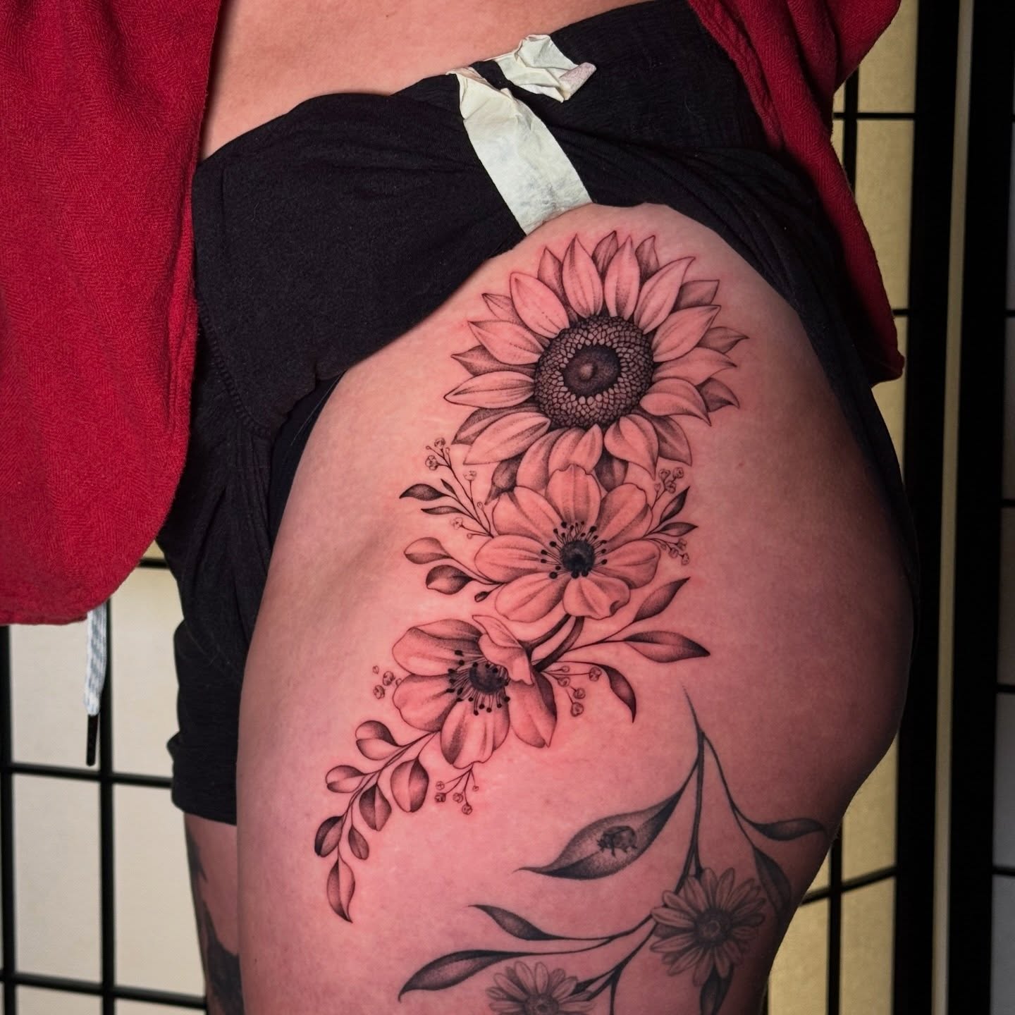 Sunflower bouquet black and grey tattoo on the thigh by Tiny