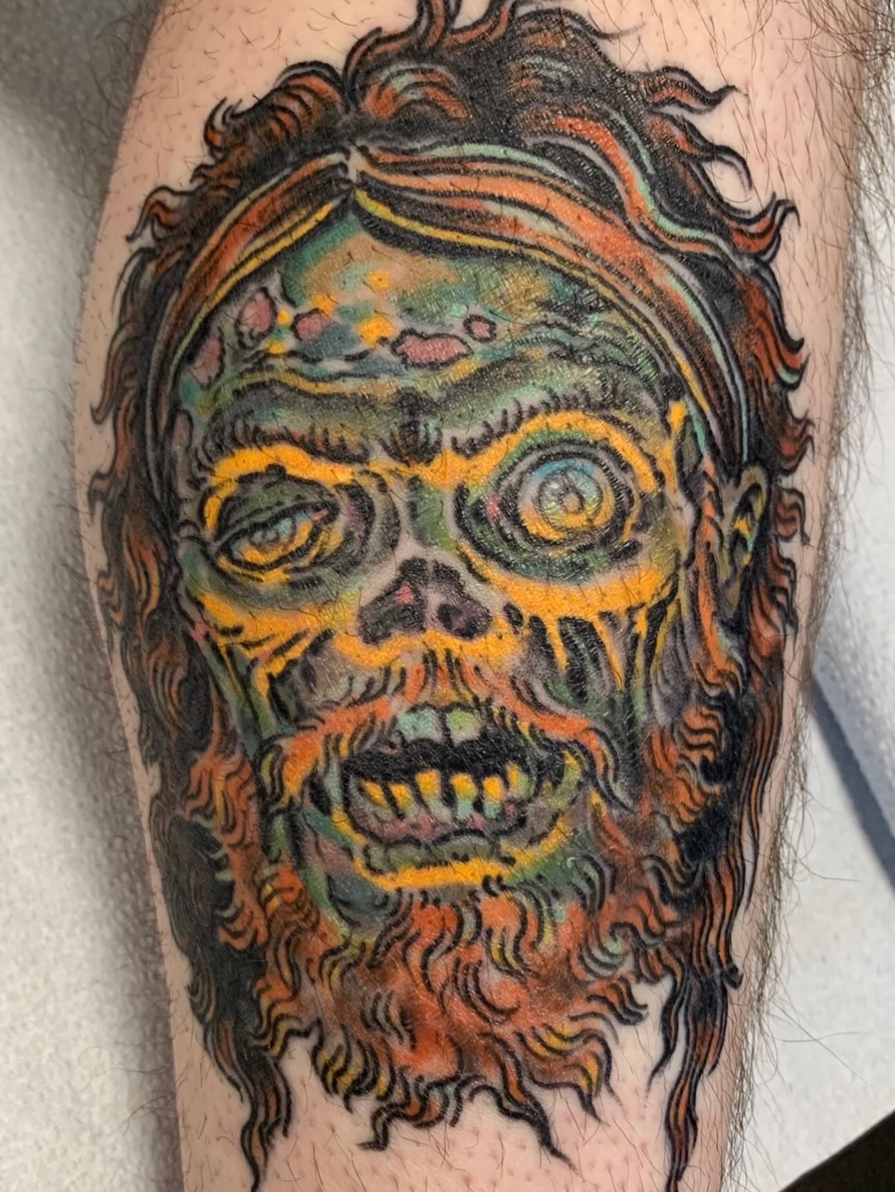 Zombie face new school tattoo on the forearm by Tim Lehi, Oakland, California