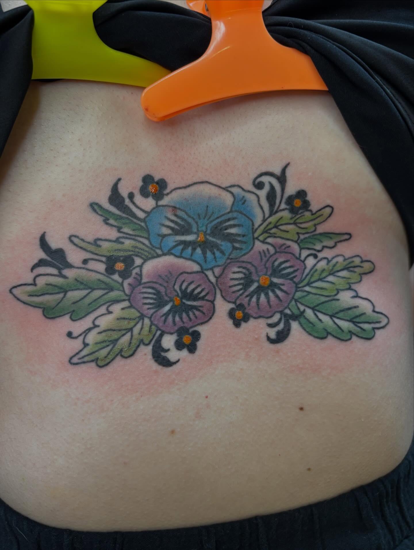 Pansies American traditional tattoo on the torso by Turner
