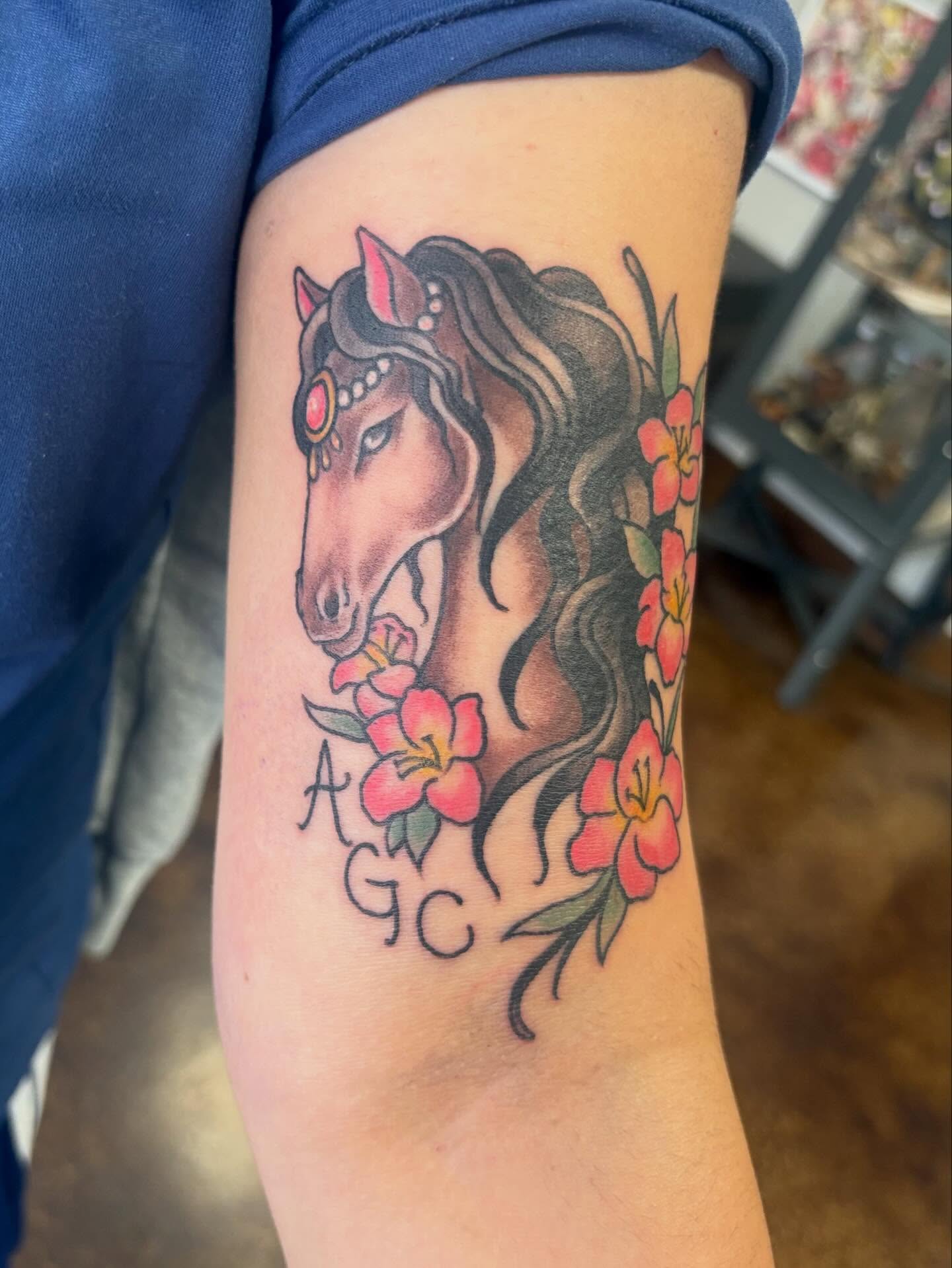 Horse and flowers realism tattoo on the forearm by Gabby, Kansas City, Missouri