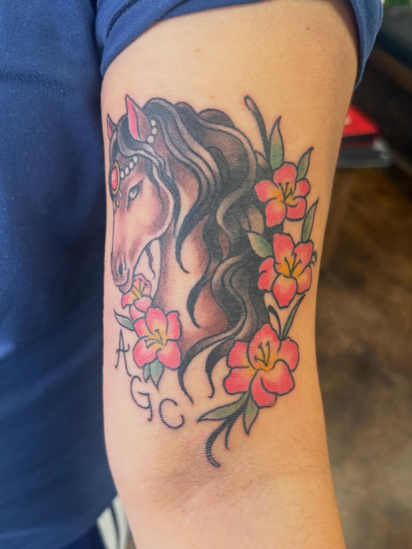 Horse and flowers realism tattoo on the forearm by Gabby, Kansas City, Missouri