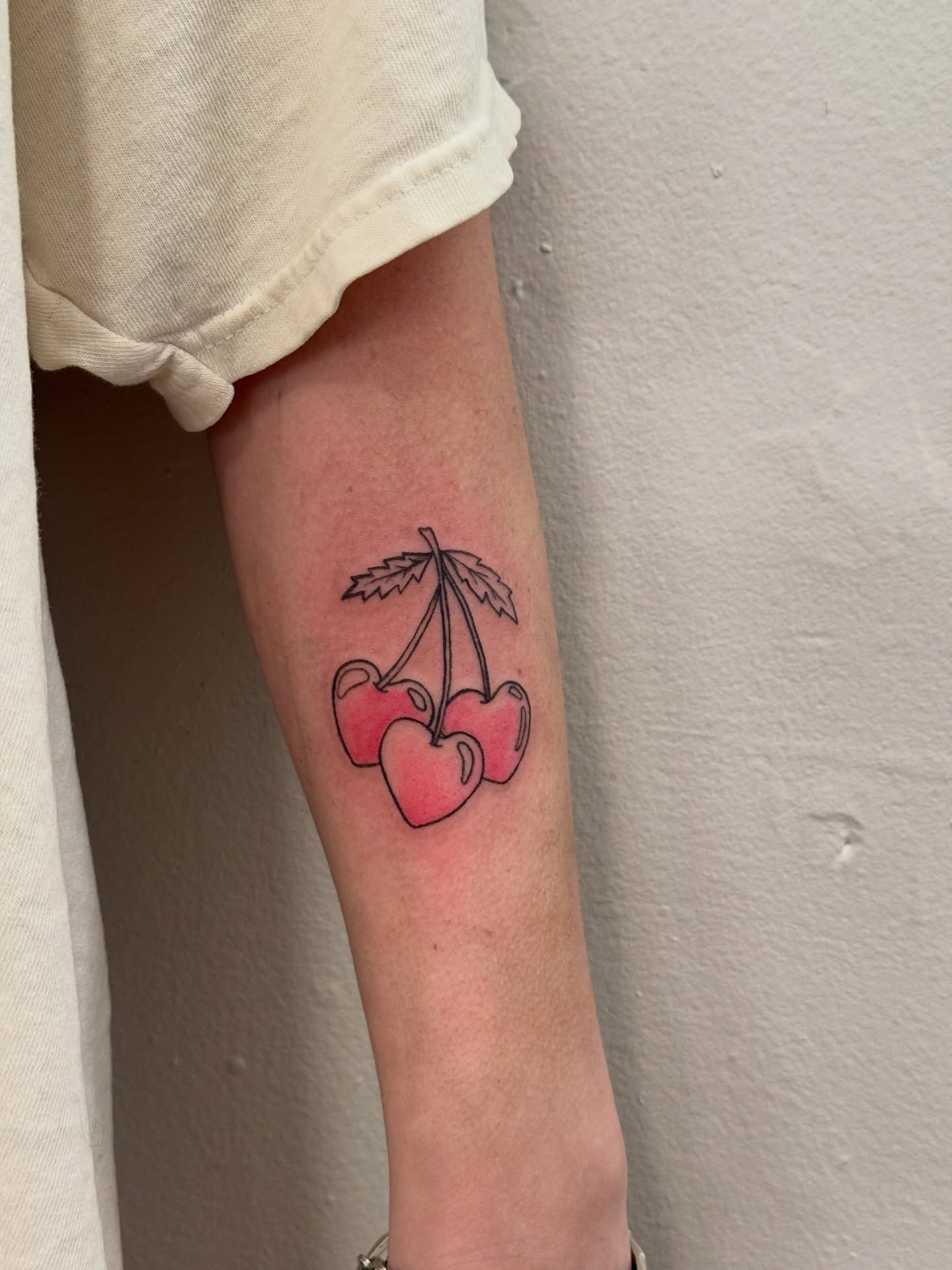 Cherries dotwork tattoo on the forearm by Lindsay Shriver