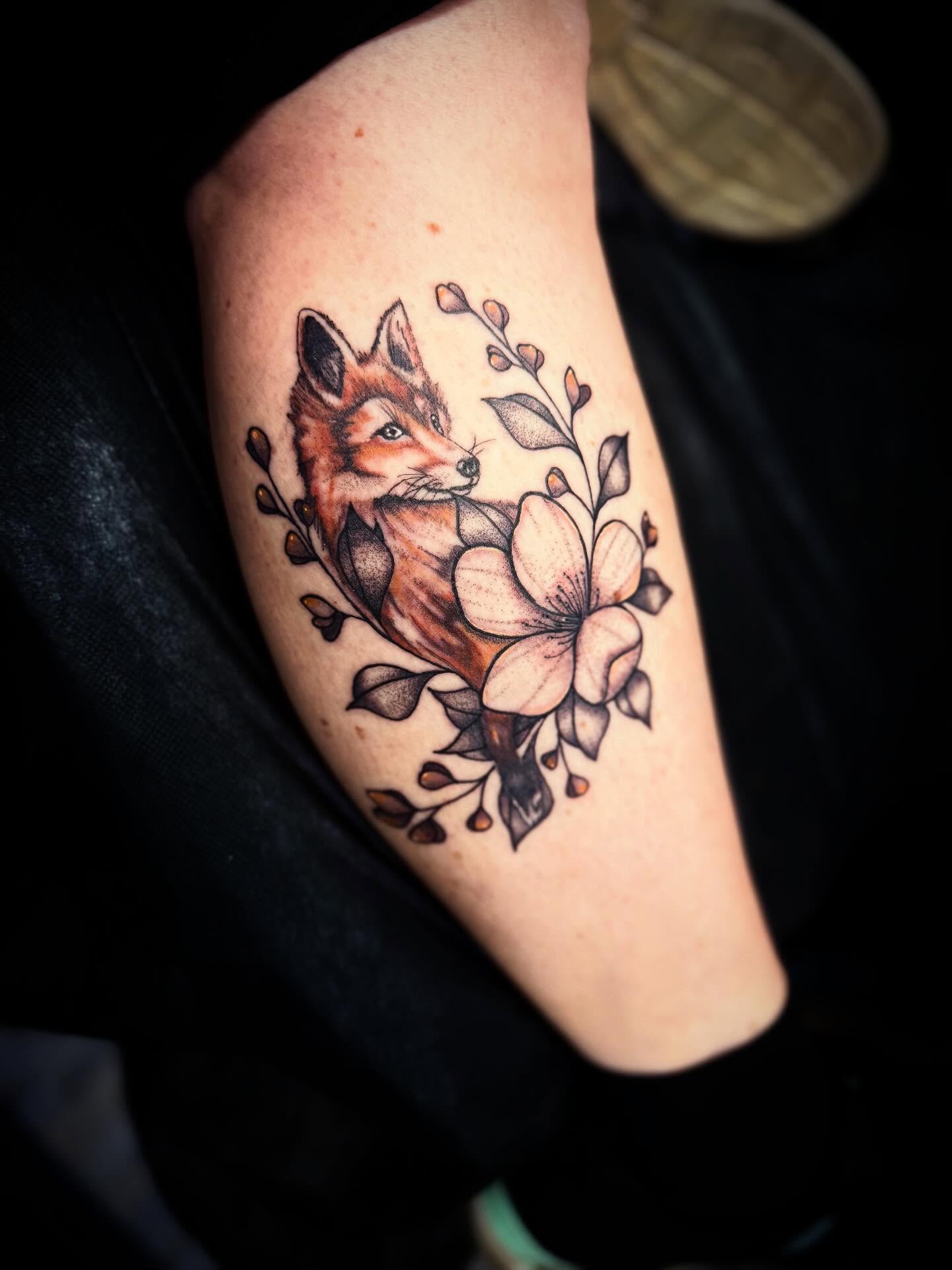 Fox and flowers realism tattoo on the forearm by Nicholas A. Estes-Davis