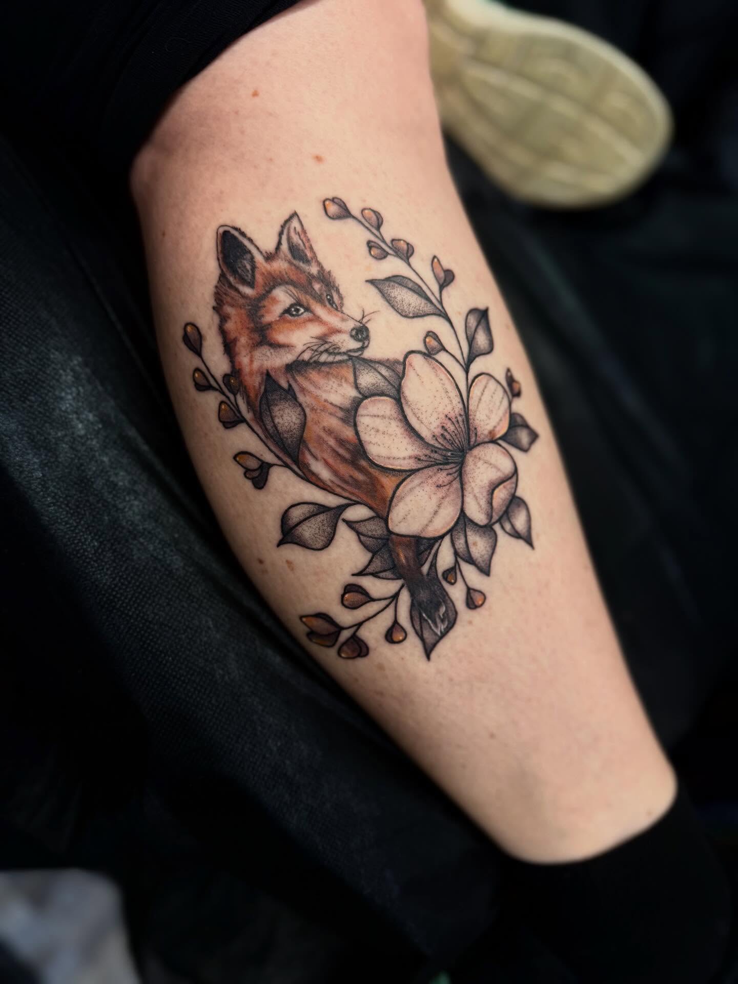 Fox and magnolia realism tattoo on the forearm by Nicholas A. Estes-Davis