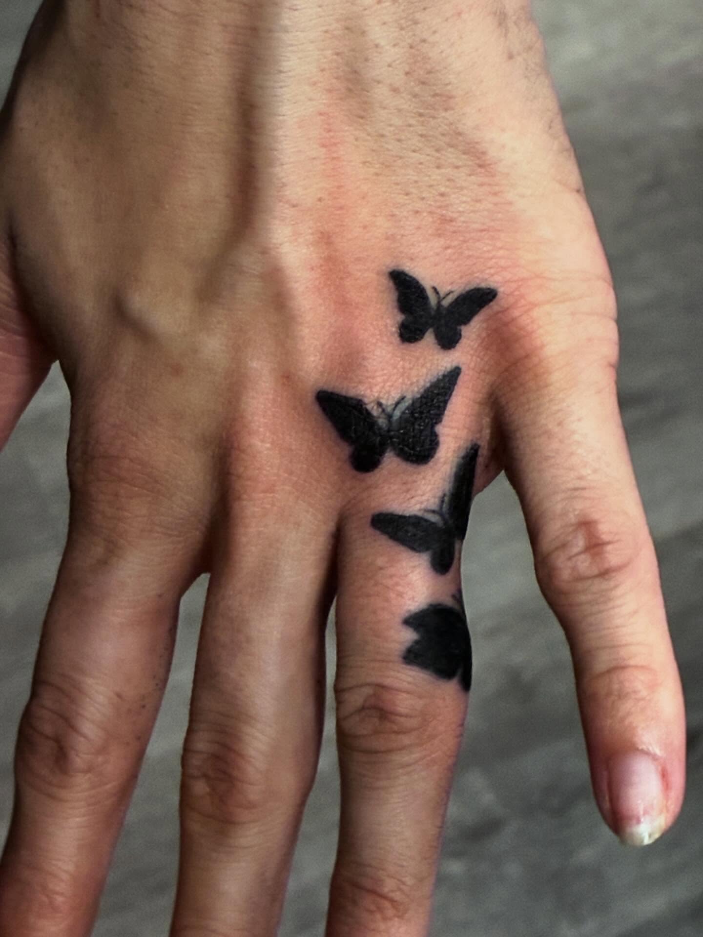 Butterflies black and grey tattoo on the hand by Trae