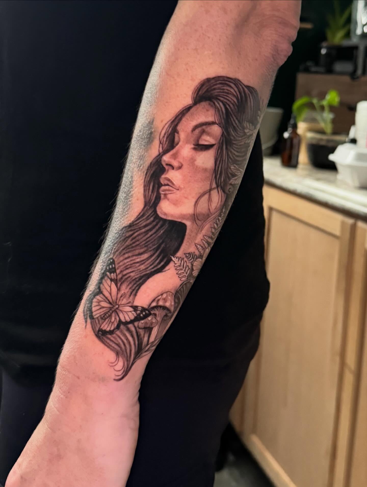 Woman with butterfly realism tattoo on the forearm by Leslea Hipp