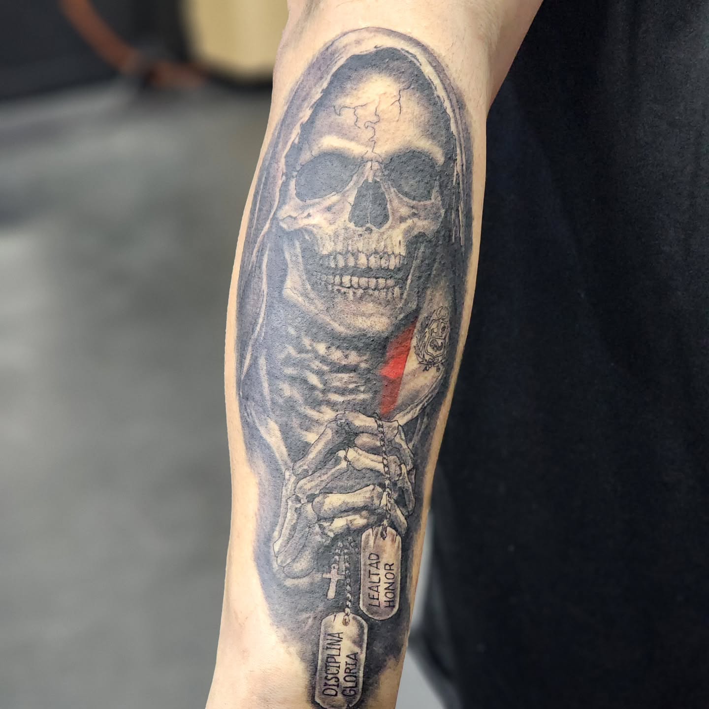 Skull with sword realism tattoo on the forearm by Robert Glover