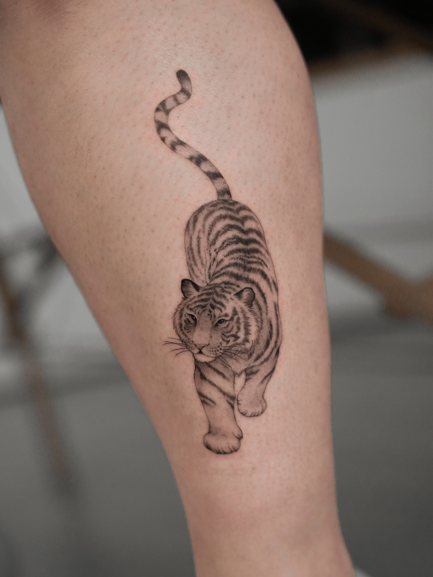 Tiger realism tattoo on the thigh by Junh Tattoo NYC