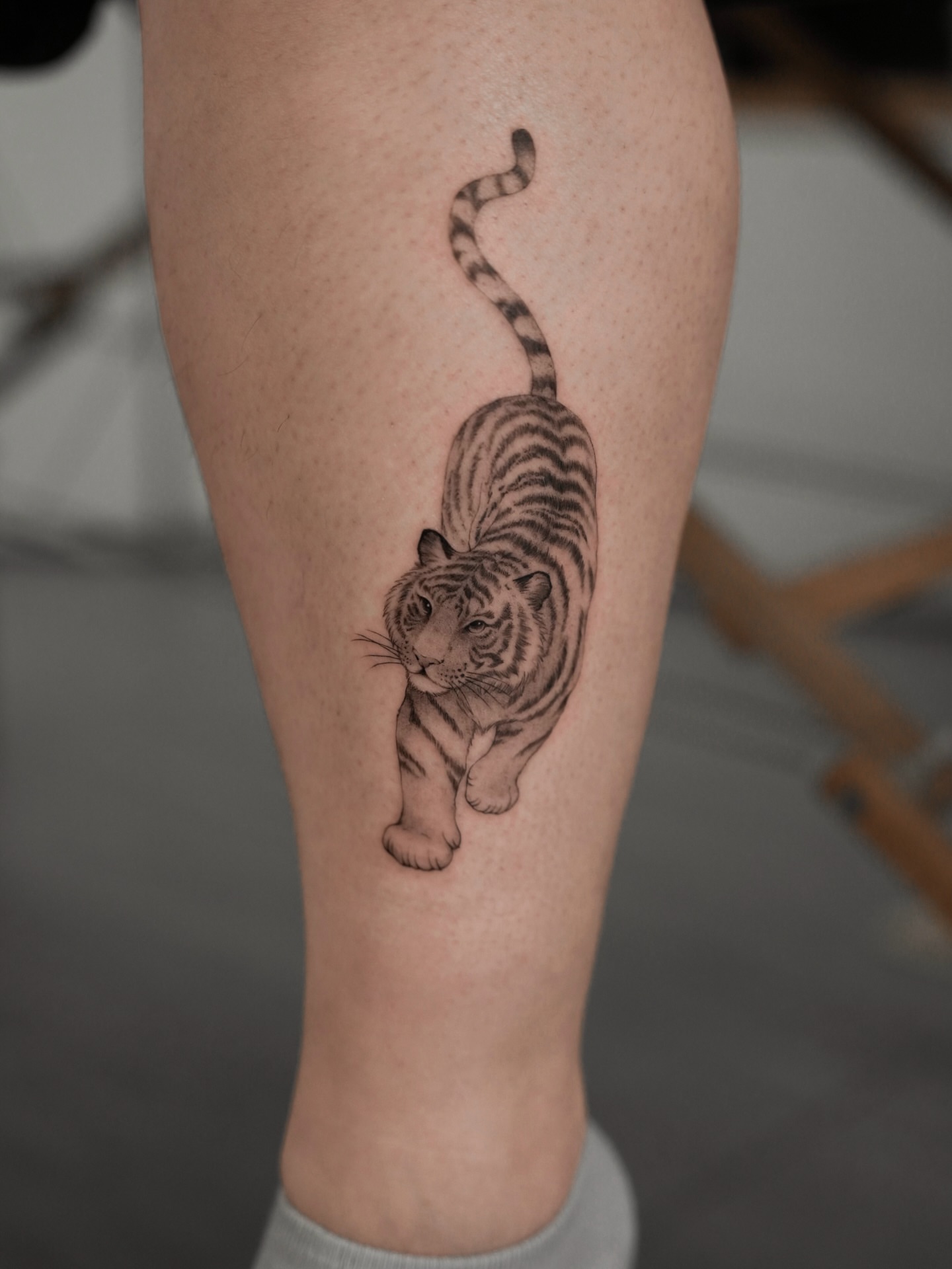 Tiger black and grey tattoo on the calf by Junh Tattoo NYC