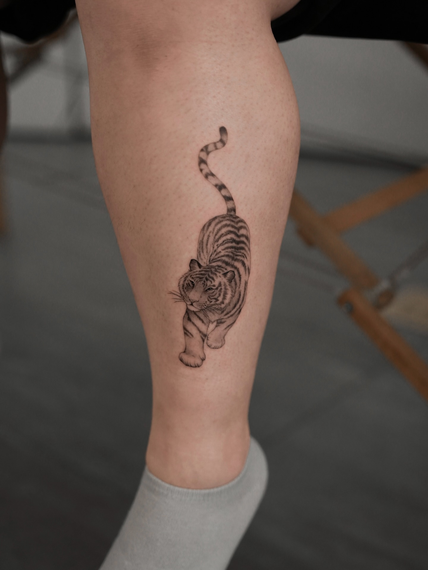 Tiger realism tattoo on the calf by Junh Tattoo NYC