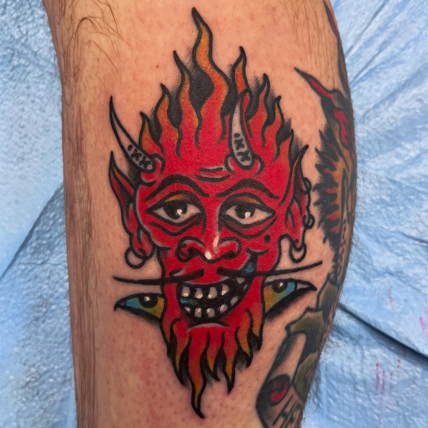 Flaming devil mask American traditional tattoo on the forearm by You’ll save me in your phone as Tattoo Tim