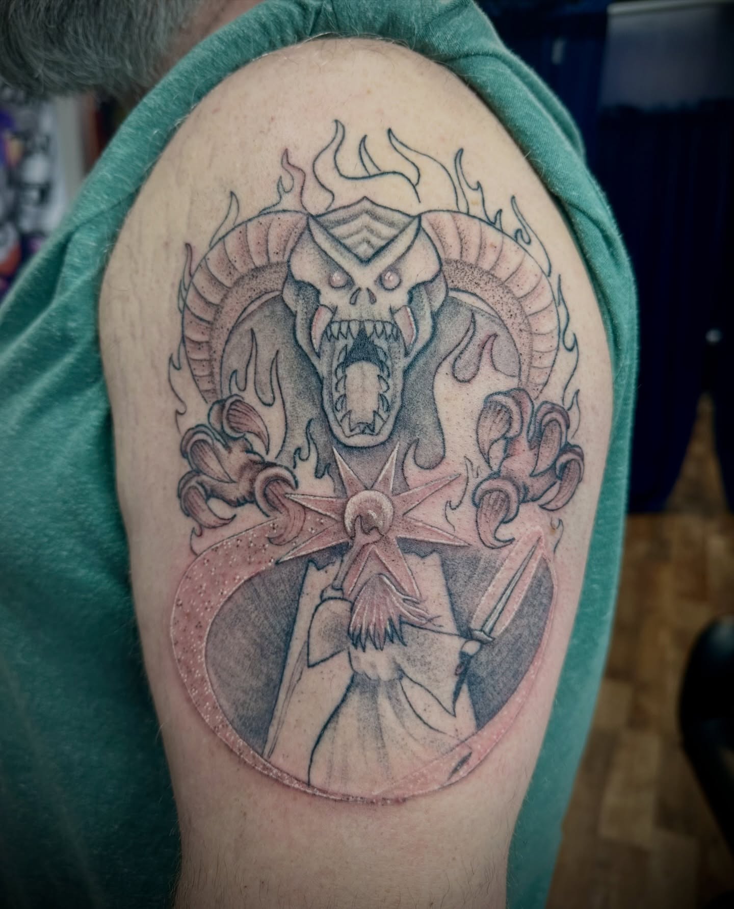 Demon and warrior realism tattoo on the shoulder by Chris Gray