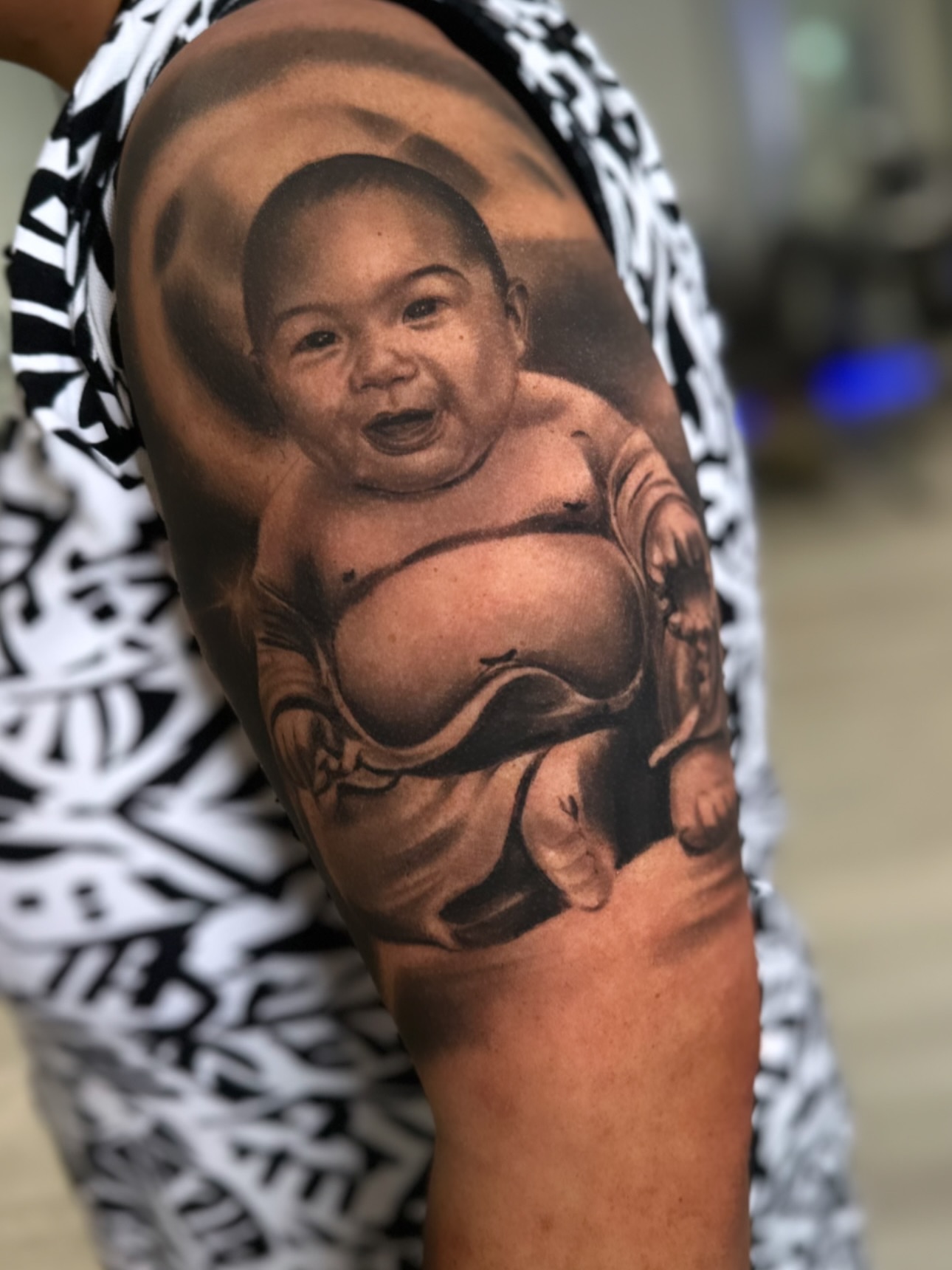 Baby realism tattoo on the upper arm by Yudel