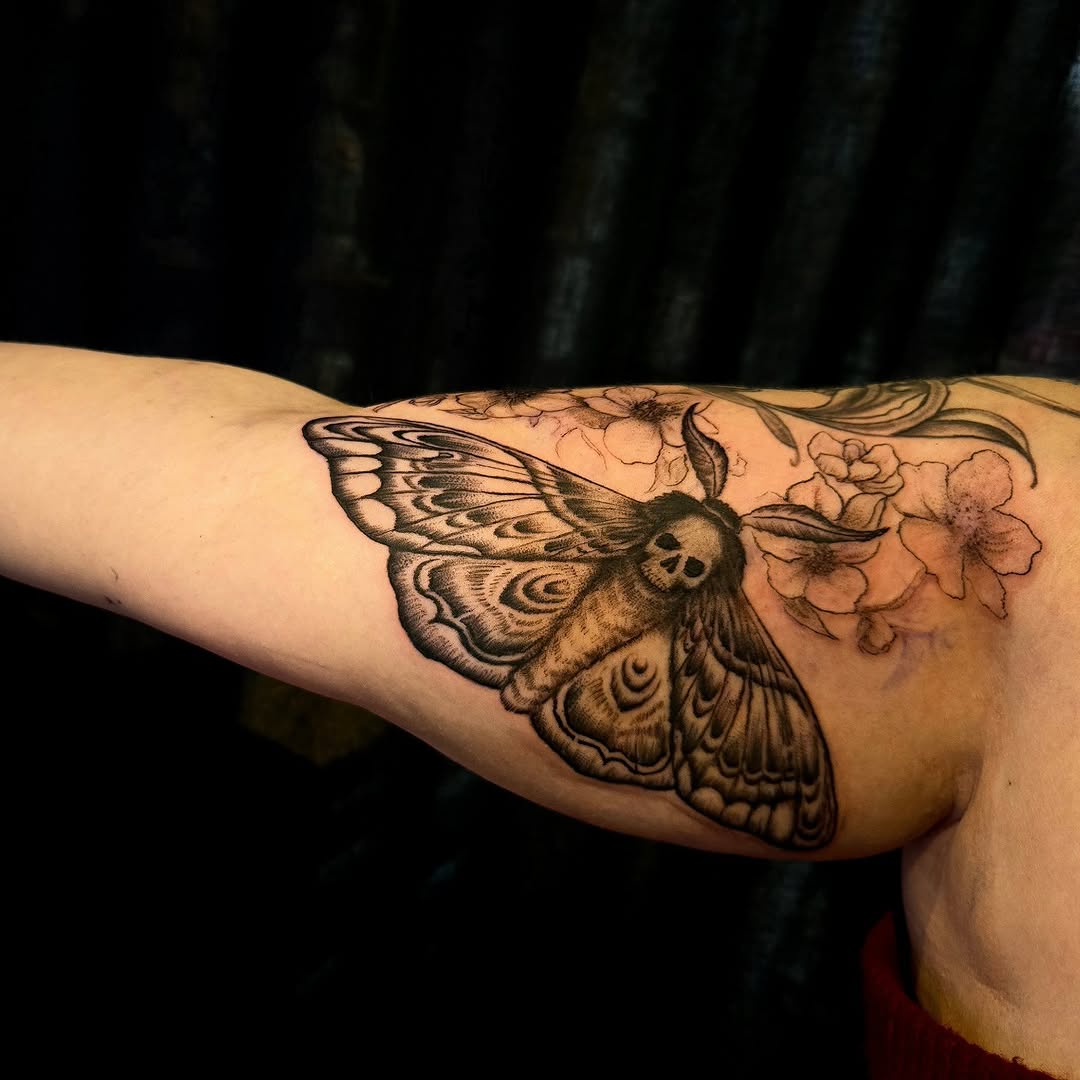 Moth with skull face and flowers fine line tattoo on the forearm by Tim Andrews