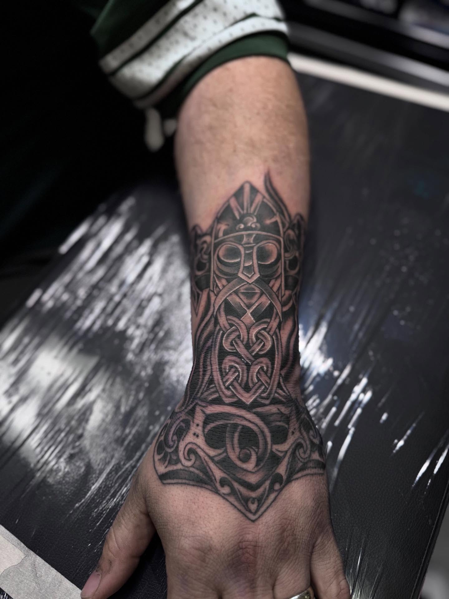 Viking helmet geometric tattoo on the forearm by Jacob - Tattoo Artist