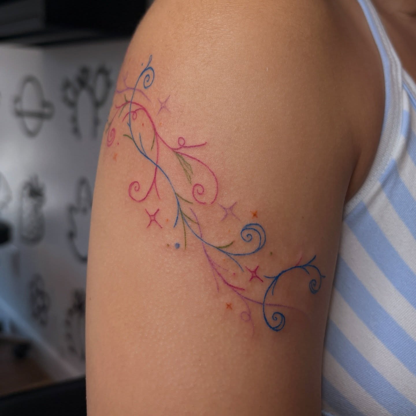 Swirls and stars fine line tattoo on the upper arm by Emma🌸✨Austin Tattoo Artist
