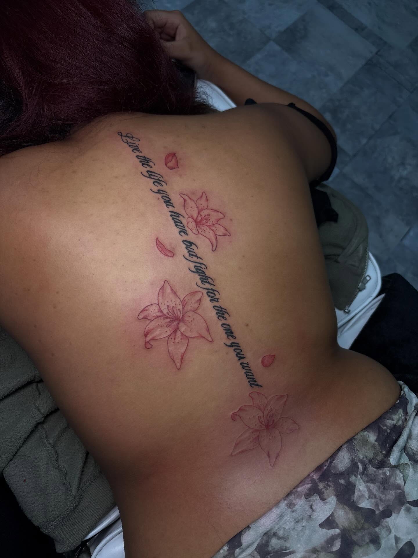 Lily flowers and script fine line tattoo on the back by addicted222inkk🎨