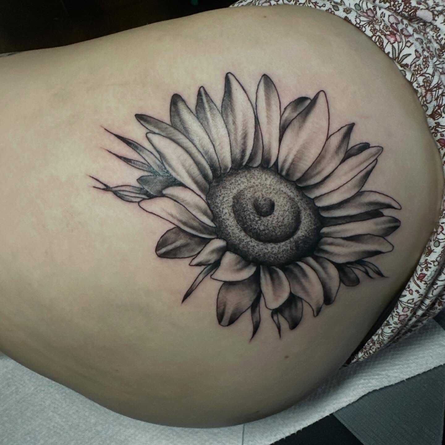 Sunflower black and grey tattoo on the thigh by Elisha B🦷