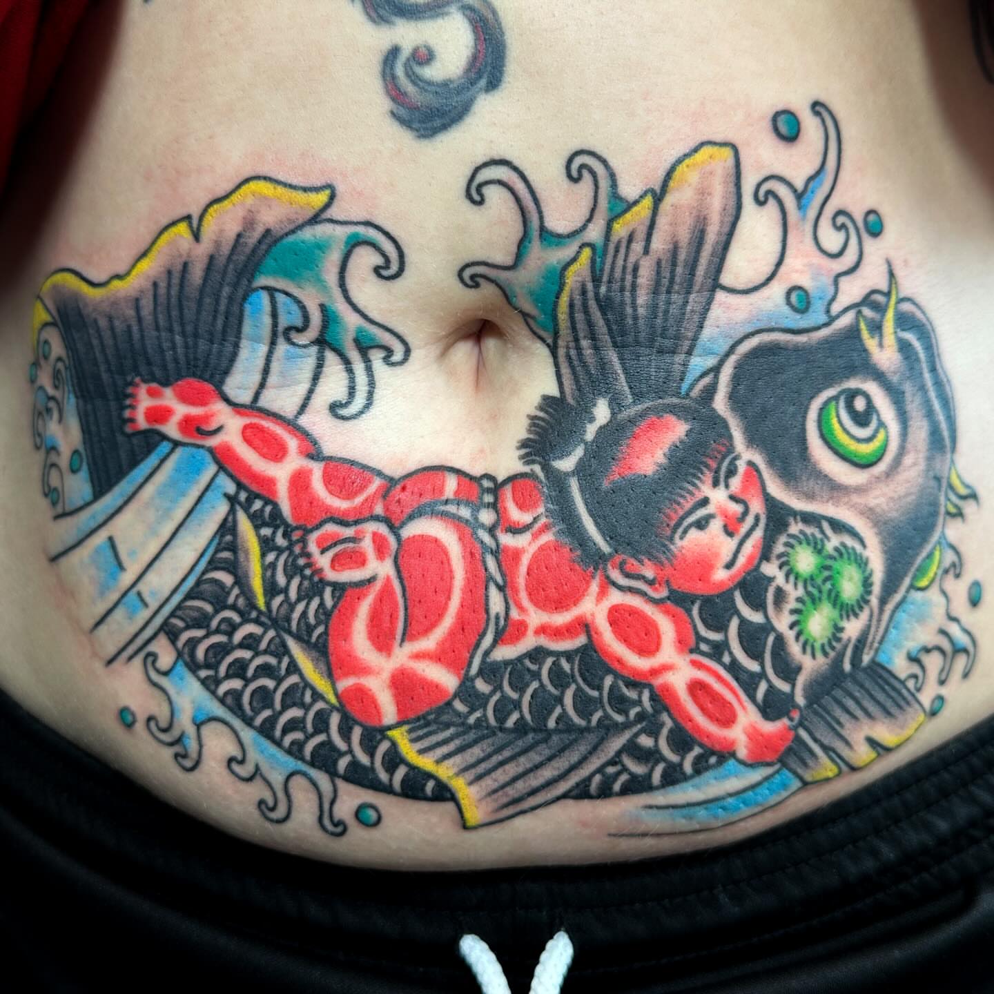 Fish and child American traditional tattoo on the torso by David Devaney, Knoxville, Tennessee