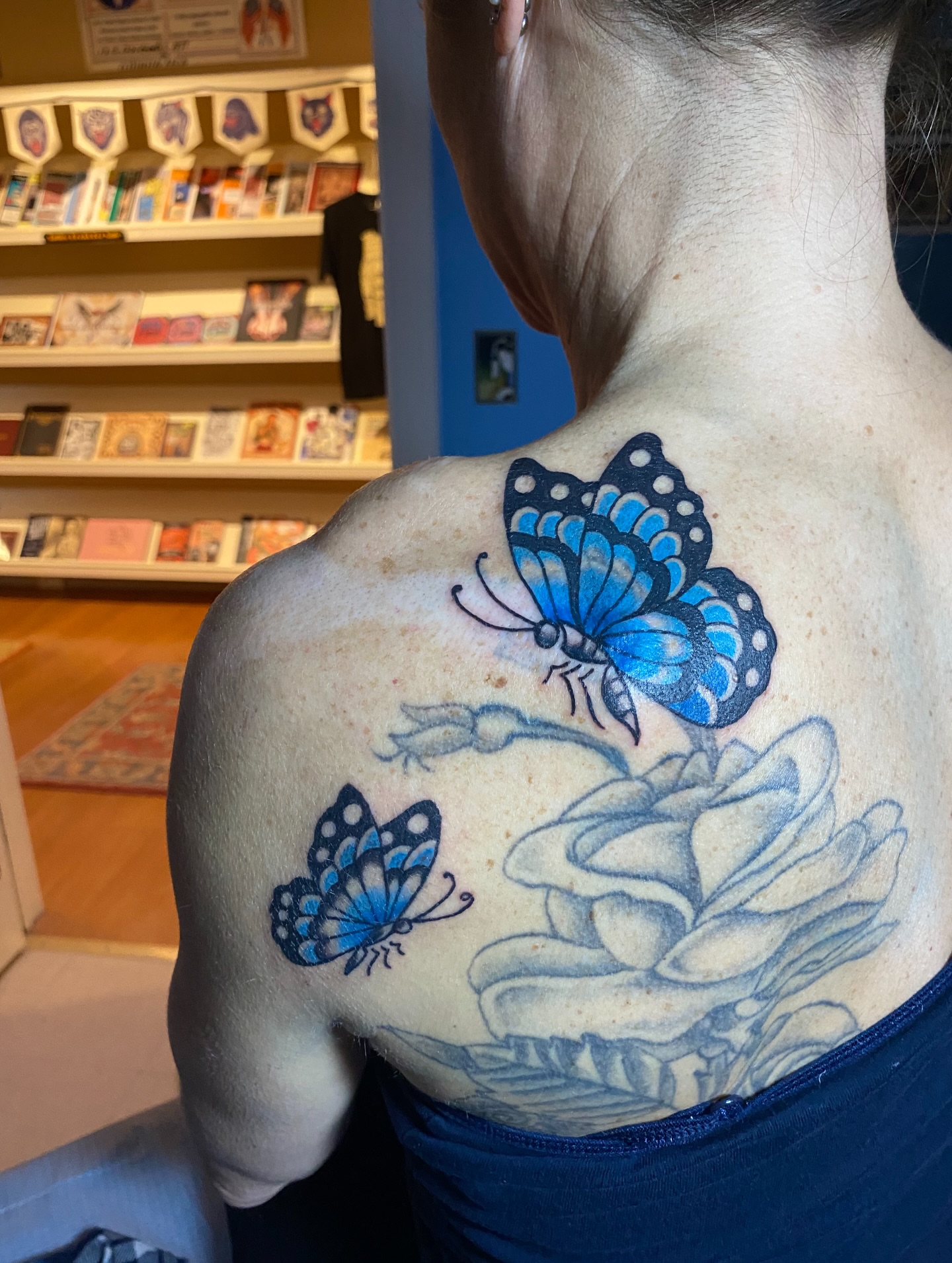 Butterfly and lotus dotwork tattoo on the back by @katie_tatts