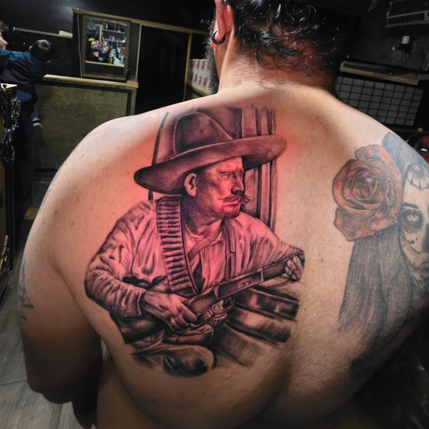 Cowboy with revolver realism tattoo on the back by komik tattoos