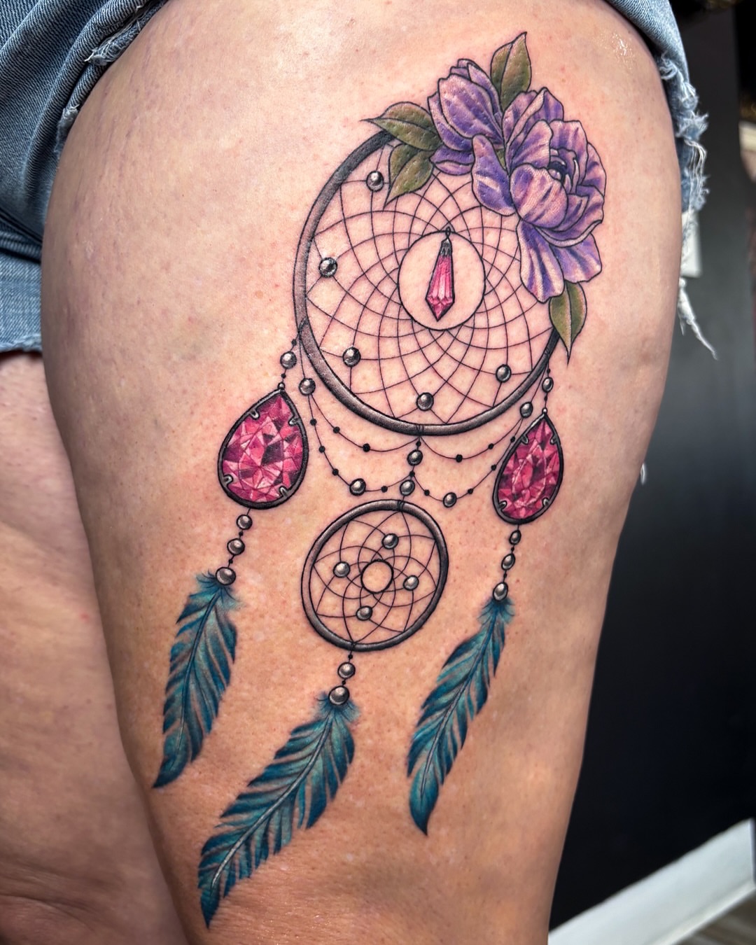 Dreamcatcher with flowers dotwork tattoo on the thigh by Shiann Null