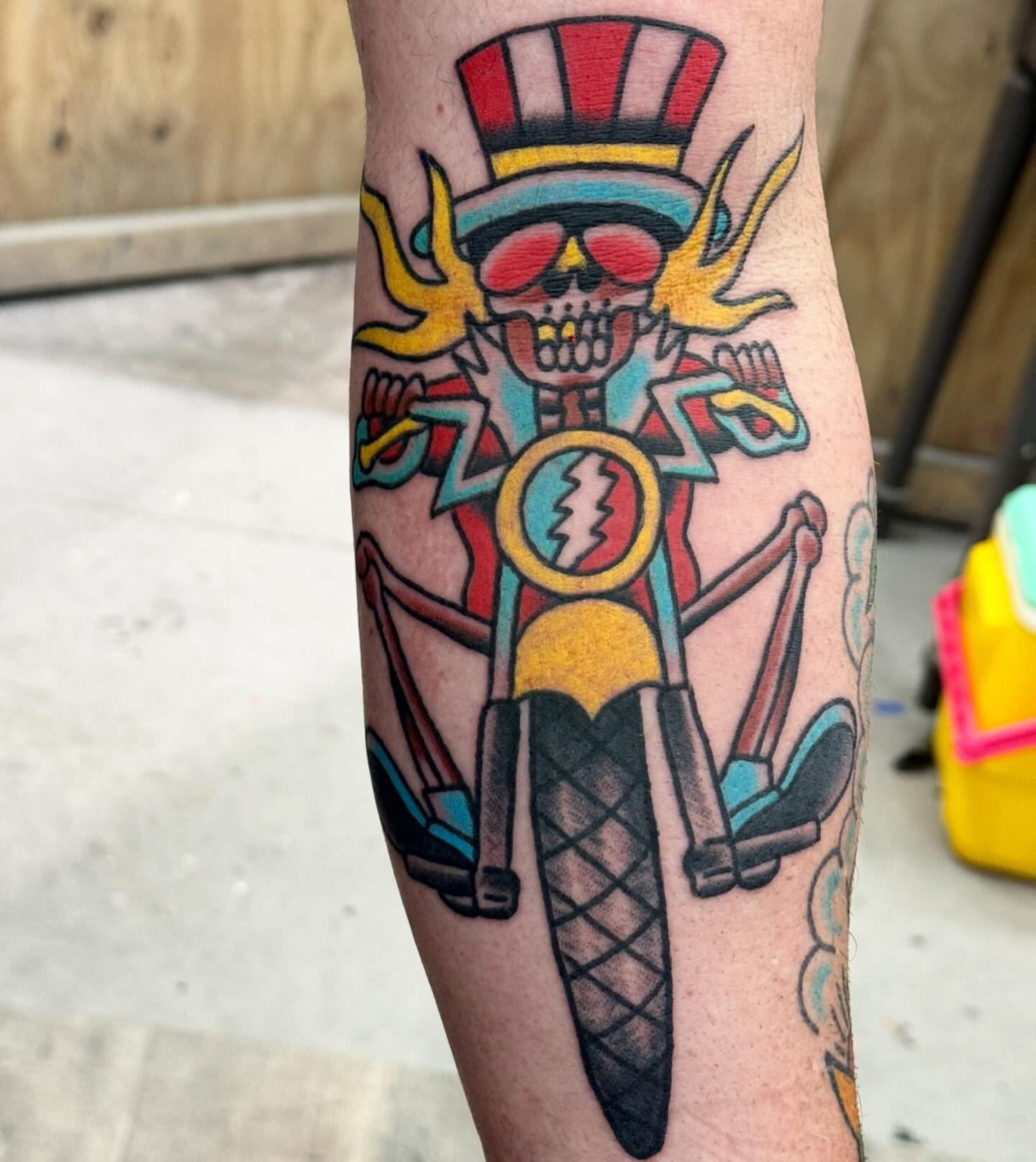 Skeleton riding motorcycle American traditional tattoo on the forearm by Sam Hambrick, Watchung NJ