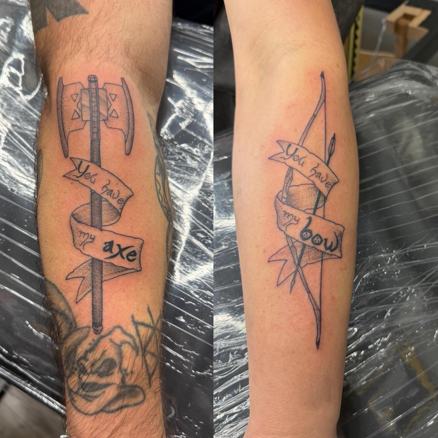 Axe and bow black and grey tattoo on the forearm by Matt Hattaway